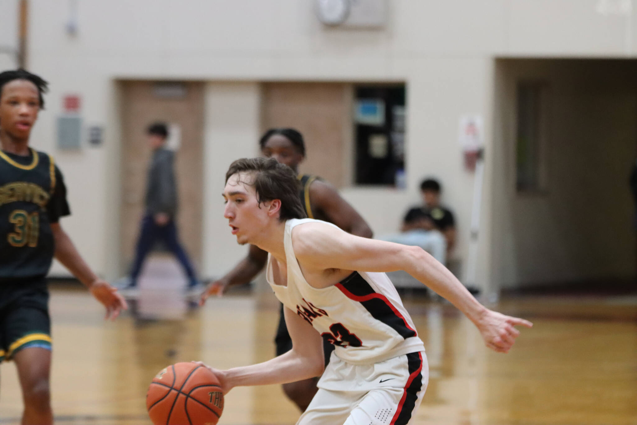 JDHS senior guard Joseph Aline takes the ball down court during one of two games against Service High School this week. (Jonson Kuhn / Juneau Empire)
