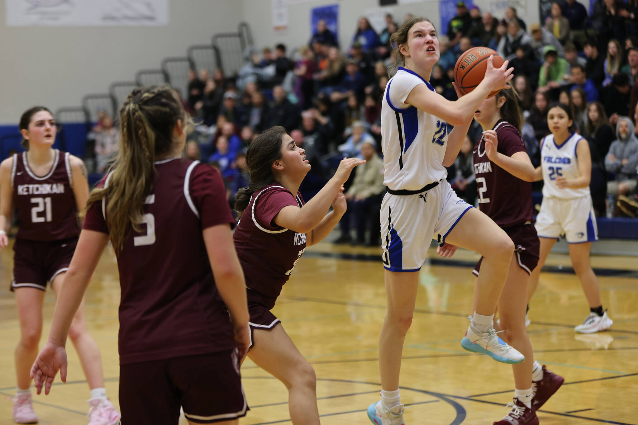 Sophomore Kerra Baxter, who led TMHS in scoring with 16 points, including a 9 points in the fourth quarter, drives toward the hoop during a Friday night home win. (Ben Hohenstatt / Juneau Empire)