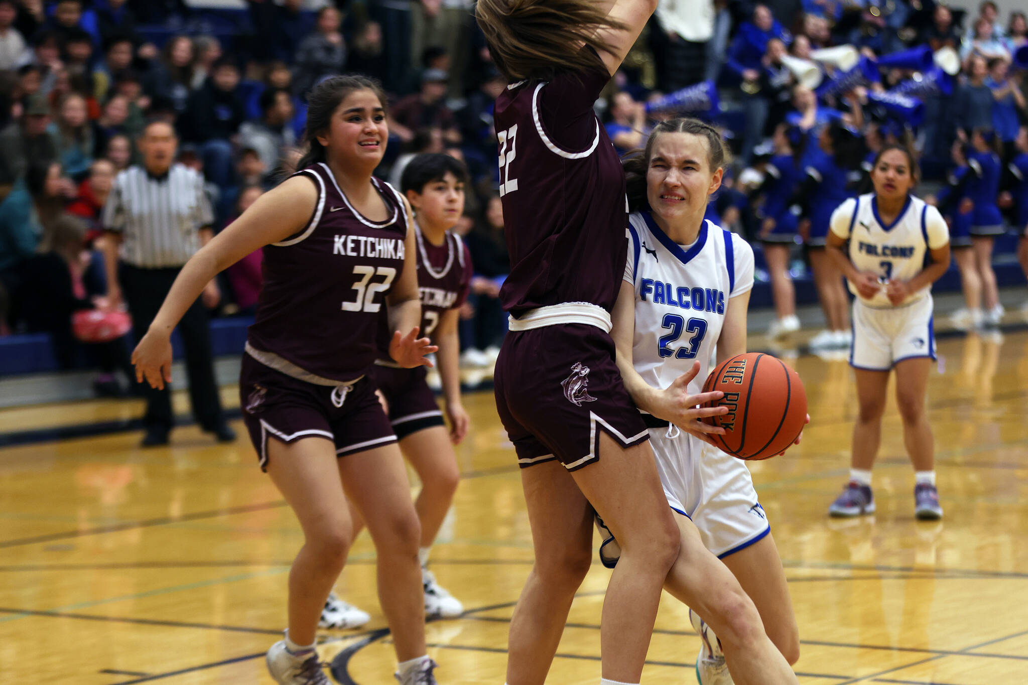 TMHS sophomore Cailynn Baxter makes contact with Kayhi junior Bree Johnson on her way to the hoop. Baxter led TMHS in scoring Saturday in a close 43-40 loss to the Lady Kings. (Ben Hohenstatt / Juneau Empire)