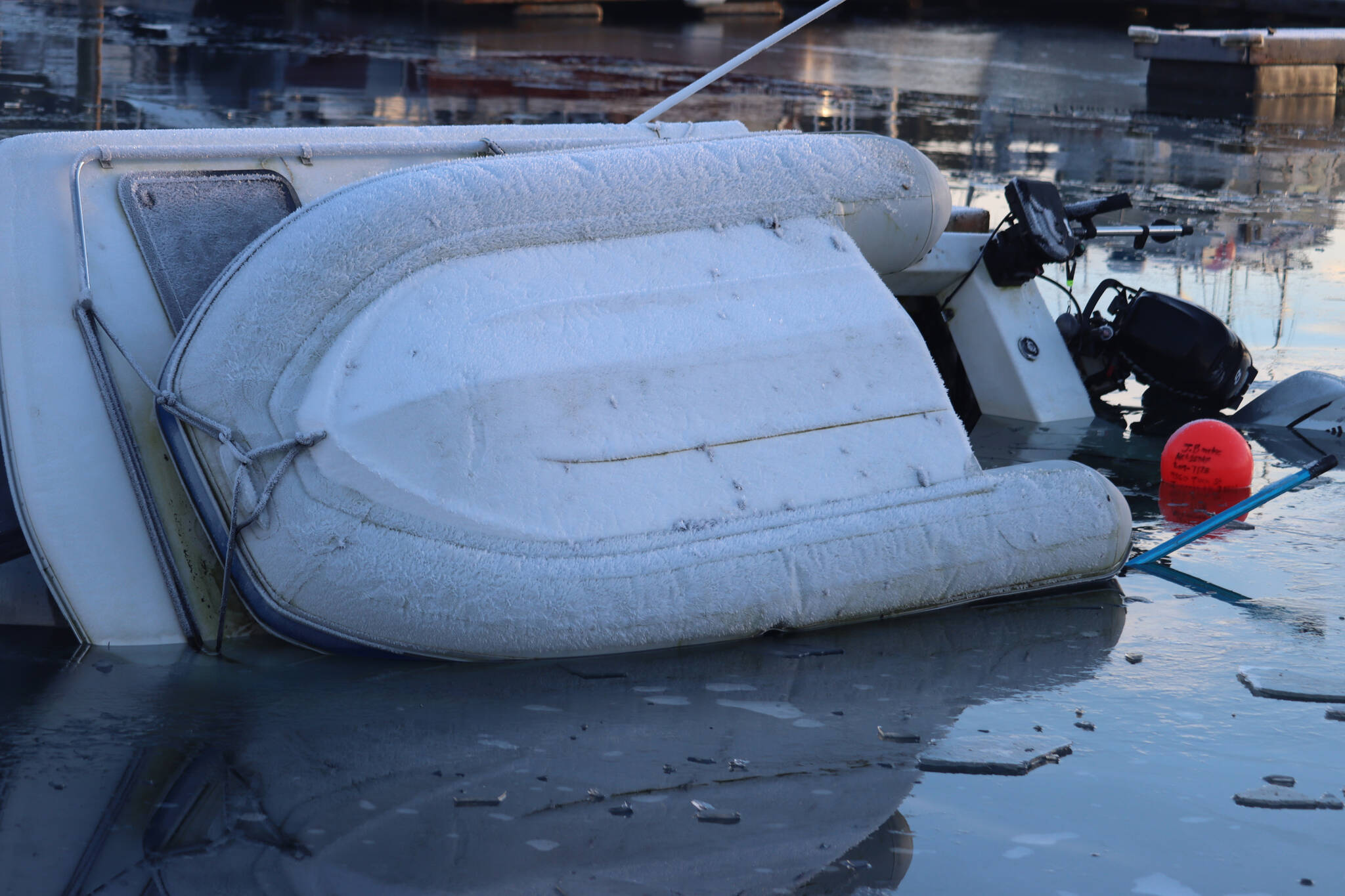 A boat sits half submerged at Fisherman’s Bend on Tuesday. According to the United States Coast Guard Maritime Information Exchange, the 26-foot recreational boat was built in 1990. (Jonson Kuhn / Juneau Empire)