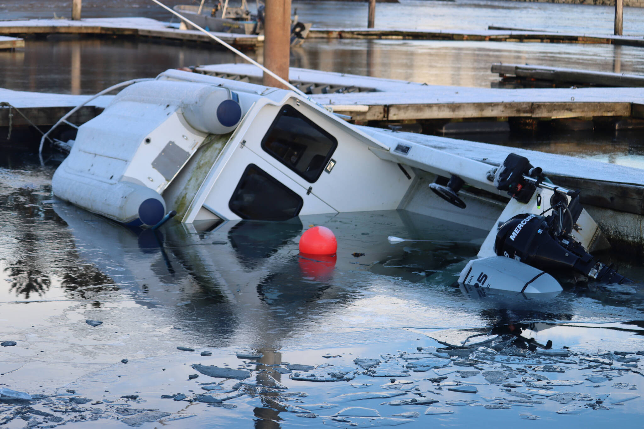 A boat sinks at Andrews Marina inside Fisherman’s Bend on Tuesday. (Jonson Kuhn / Juneau Empire)