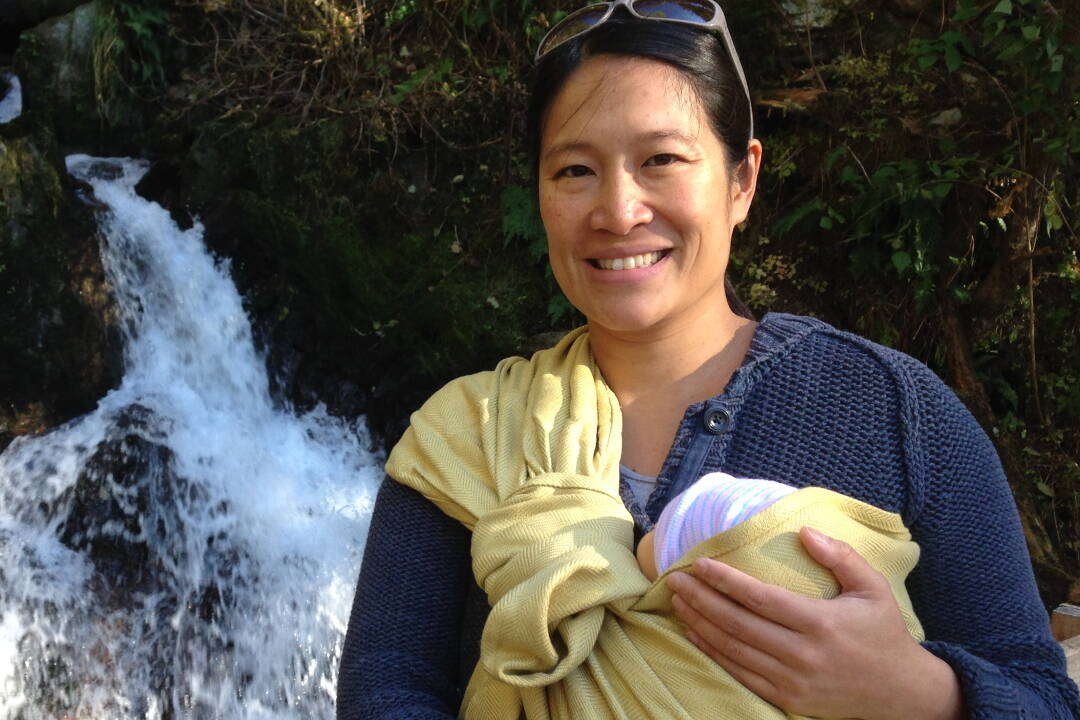Lisa Phu holds her daughter, Acacia, near a waterfall on a trail just south of Thane in October of 2016.(Courtesy of Lisa Phu)