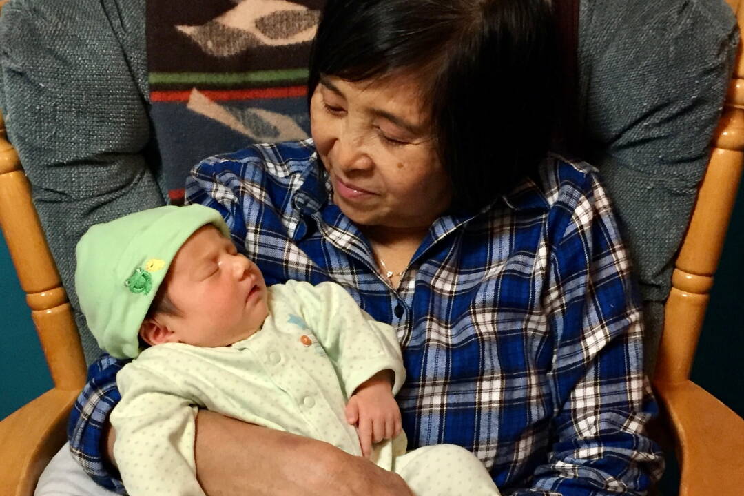 Lan Phu holds her granddaughter, Acacia, at Lisa Phu’s home in Juneau in October of 2016. (Courtesy of Lisa Phu)