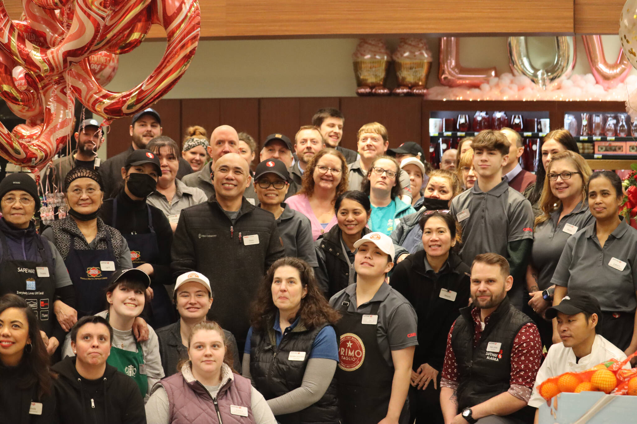 Safeway employees and store managers pose for a group photo on Wednesday after a grand reopening ceremony was held to celebrate the completion of many remodeling projects. (Jonson Kuhn / Juneau Empire)