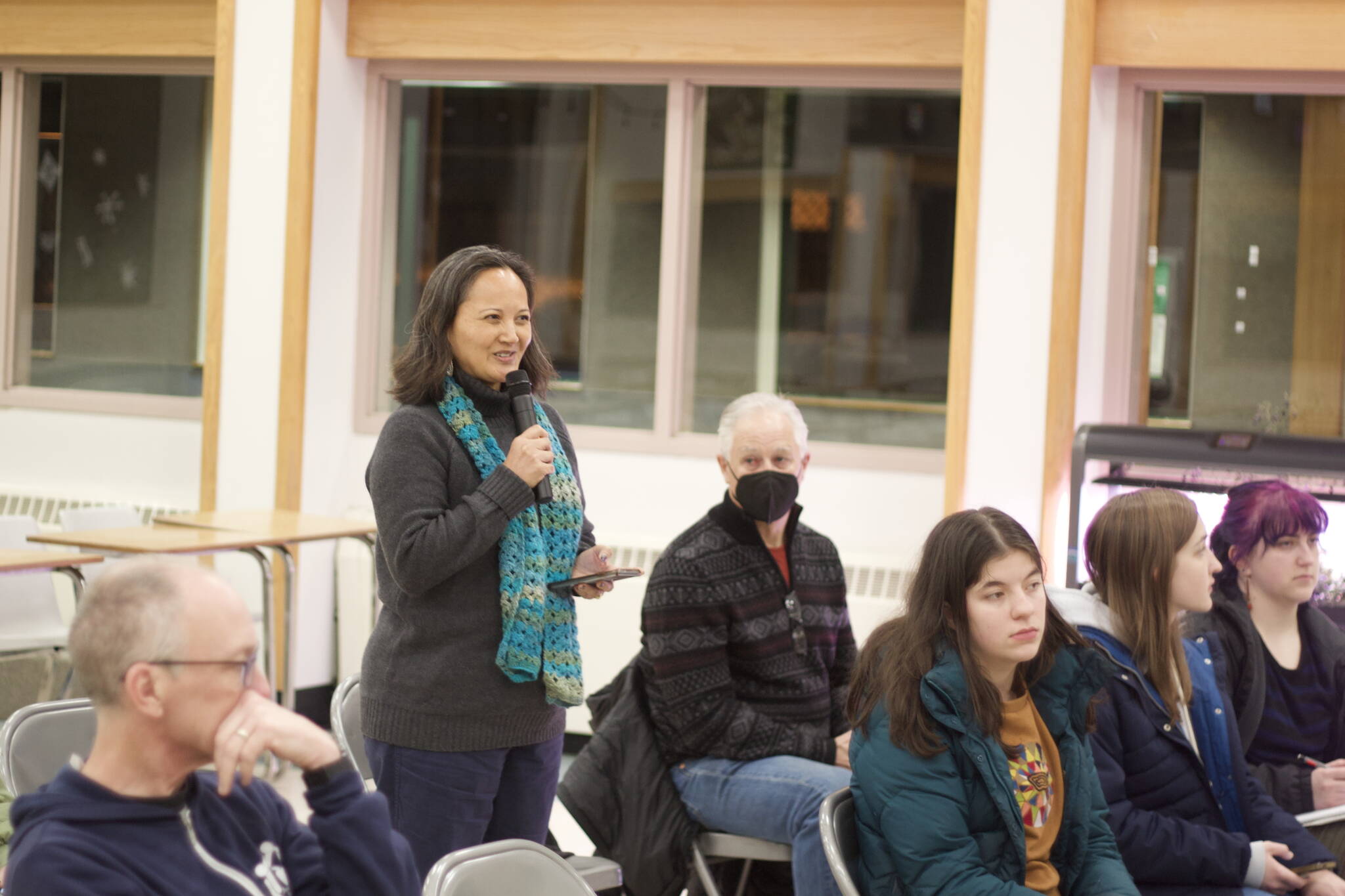 Lisa X’unyéil Worl, a longtime advocate for education and other issues, asks Juneau’s legislative delegation about the prospects for public broadcasting funding from the state during a town hall meeting Wednesday evening at Dzantik’i Heeni Middle School. (Mark Sabbatini / Juneau Empire)