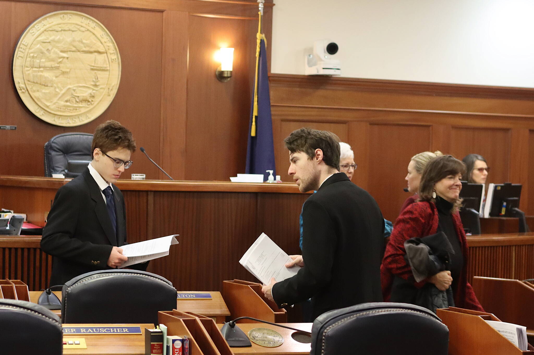 Mark Sabbatini / Juneau Empire 
House pages distribute scripts for a mock floor session Friday. The script, featuring obviously fake proposed legislation, guided legislators though the various complexities that can arise during everyday business while in session.
