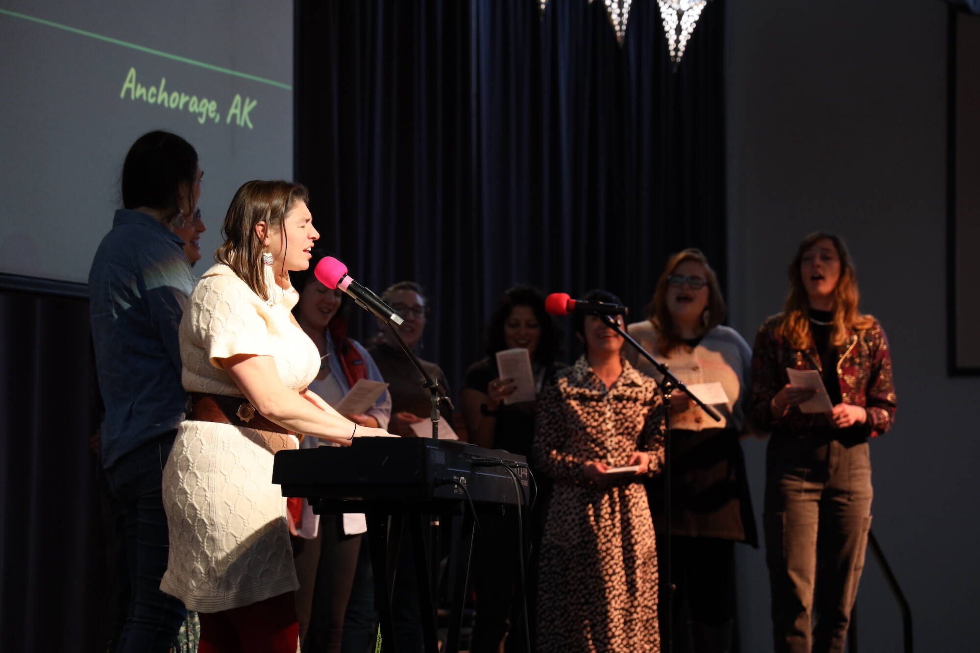 Kat Moore and a group of volunteer singers sang mid way through the Alaska Music Summit on Saturday at the Juneau Arts and Culture Center. Moore was a speaker and performer at the event who traveled from Anchorage to attend. (Clarise Larson / Juneau Empire)