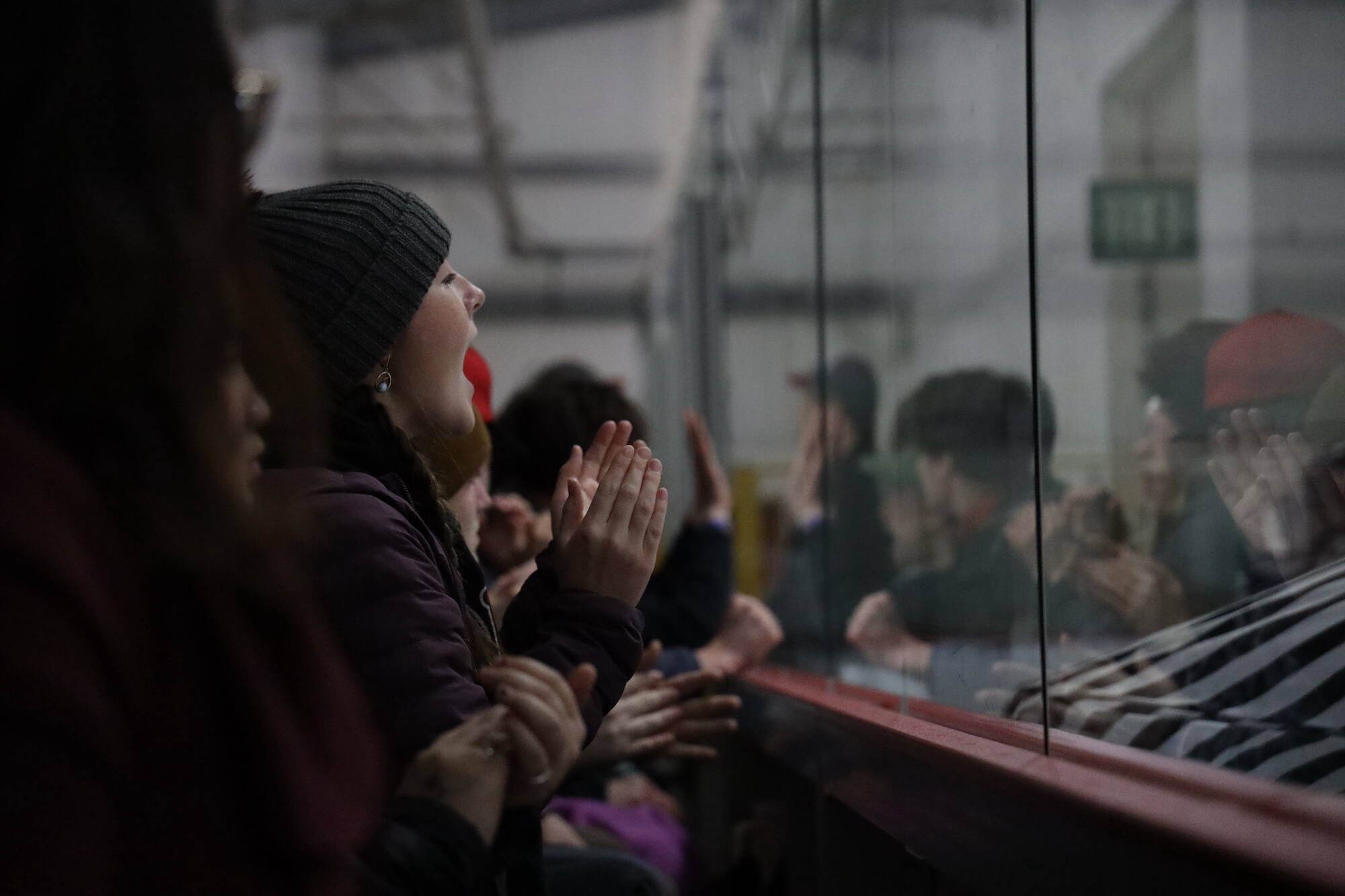 A fan shout during the overtime period at the Juneau-Douglas High School: Yadaa.at Kalé Crimson Bears hockey game against the Soldotna High School Stars on Saturday. (Clarise Larson / Juneau Empire)