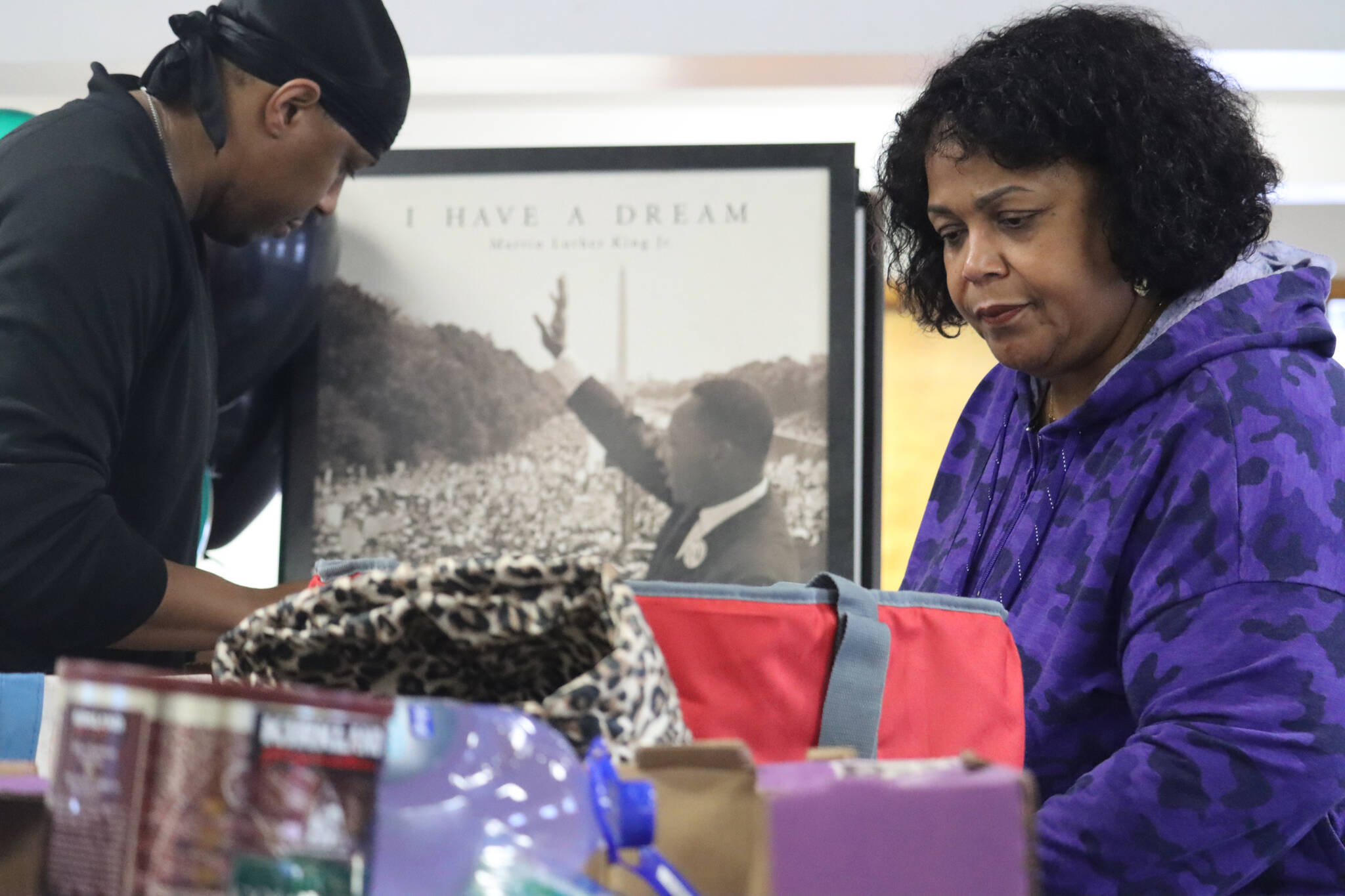 Sherry Patterson and her son Michael sort through the large pile of donations received on Monday as part of the Black Awareness Association of Juneau’s annual collection drive at St. Paul’s Catholic Church. (Jonson Kuhn / Juneau Empire)