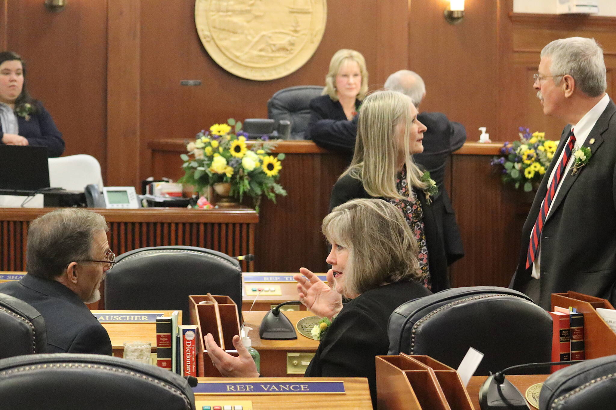 Juneau Democratic state Reps. Sara Hannan, center left, and Andi Story, center right, chat with fellow lawmakers minutes before the House was called to order at 2:05 p.m. Tuesday at the Alaska State Capitol. (Mark Sabbatini / Juneau Empire)