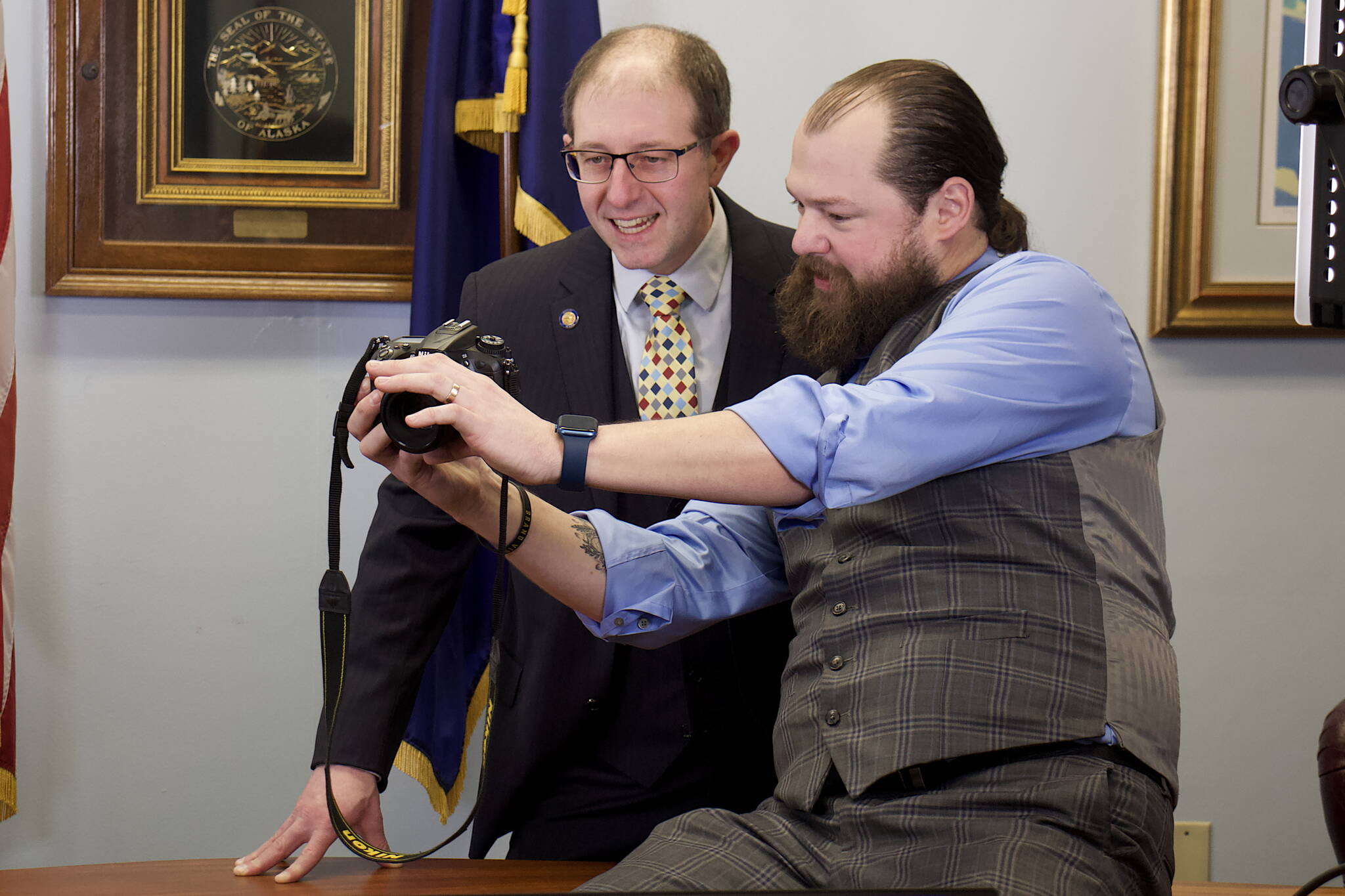 State Sen. Jesse Kiehl of Juneau, left, examines photos taken for his official portrait by Noah Hanson, communications director for the senate majority, in a meeting room at the Alaska State Capitol a few hours before the Senate gaveled in to officially start the 33rd Alaska State Legislature. (Mark Sabbatini / Juneau Empire) Alaska Senate Majority (Mark Sabbatini / Juneau Empire)