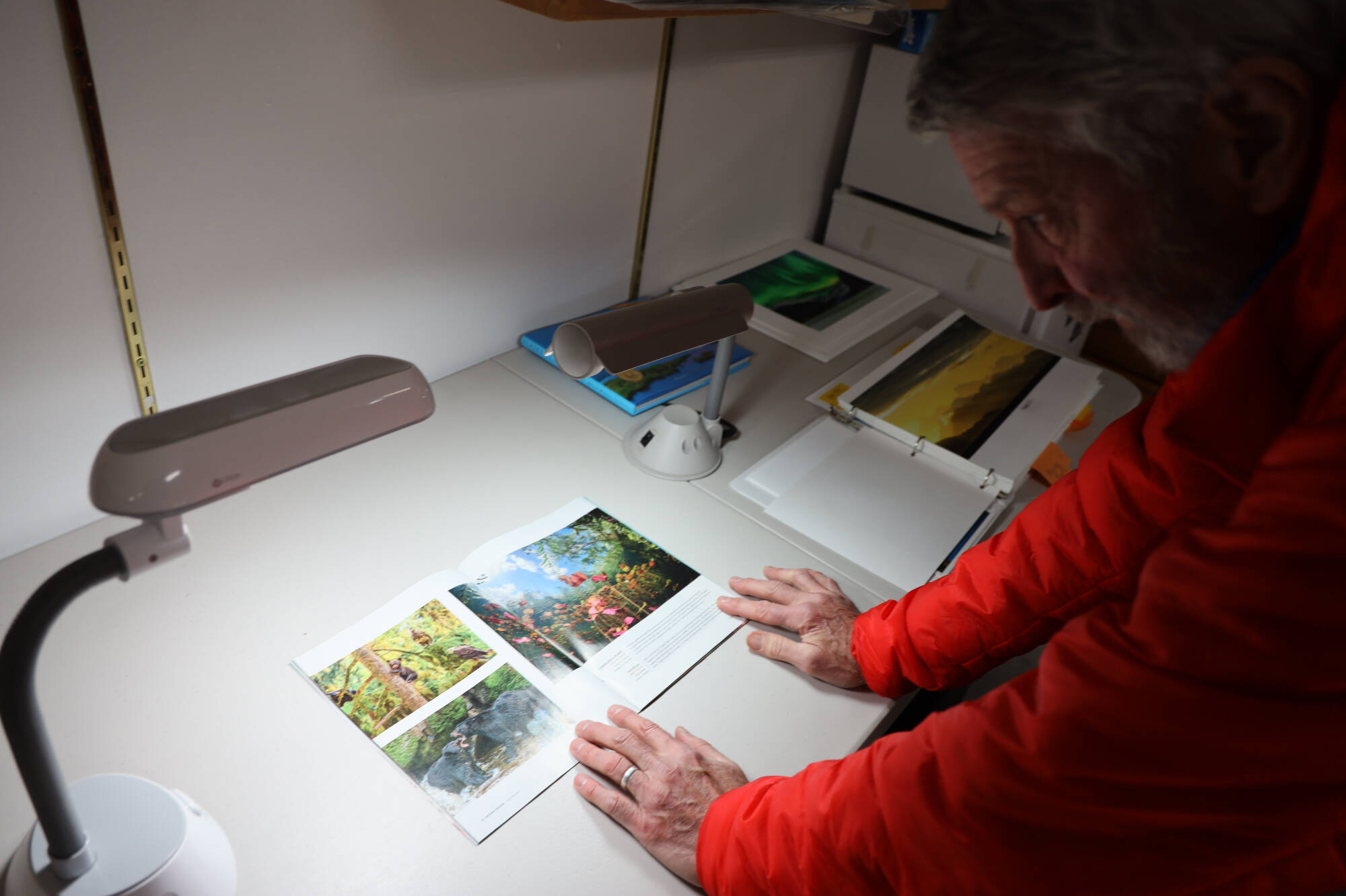Mark Kelley analyses some of his photos that were featured in the print edition of the 2022 National Wildlife Magazine photo contest edition. Each photo included in his portfolio was closely examined and deliberated on before he settled with the final 10 photos that built the body of work. (Clarise Larson / Juneau Empire)