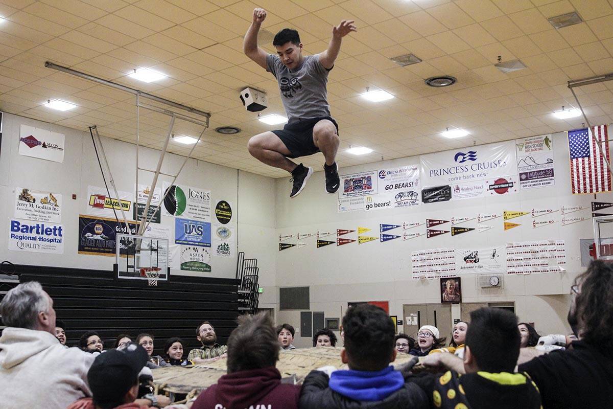 Kyle Worl gets launched into the air as he demonstrates the blanket toss at Juneau-Douglas High School: Yadaa.at Kalé before the start of the 2020 Traditional Games, March 6, 2020. The 2023 Traditional Games will take place at Thunder Mountain High School on Saturday and Sunday, April 1-2. Registration is now open. (Michael S. Lockett / Juneau Empire File)