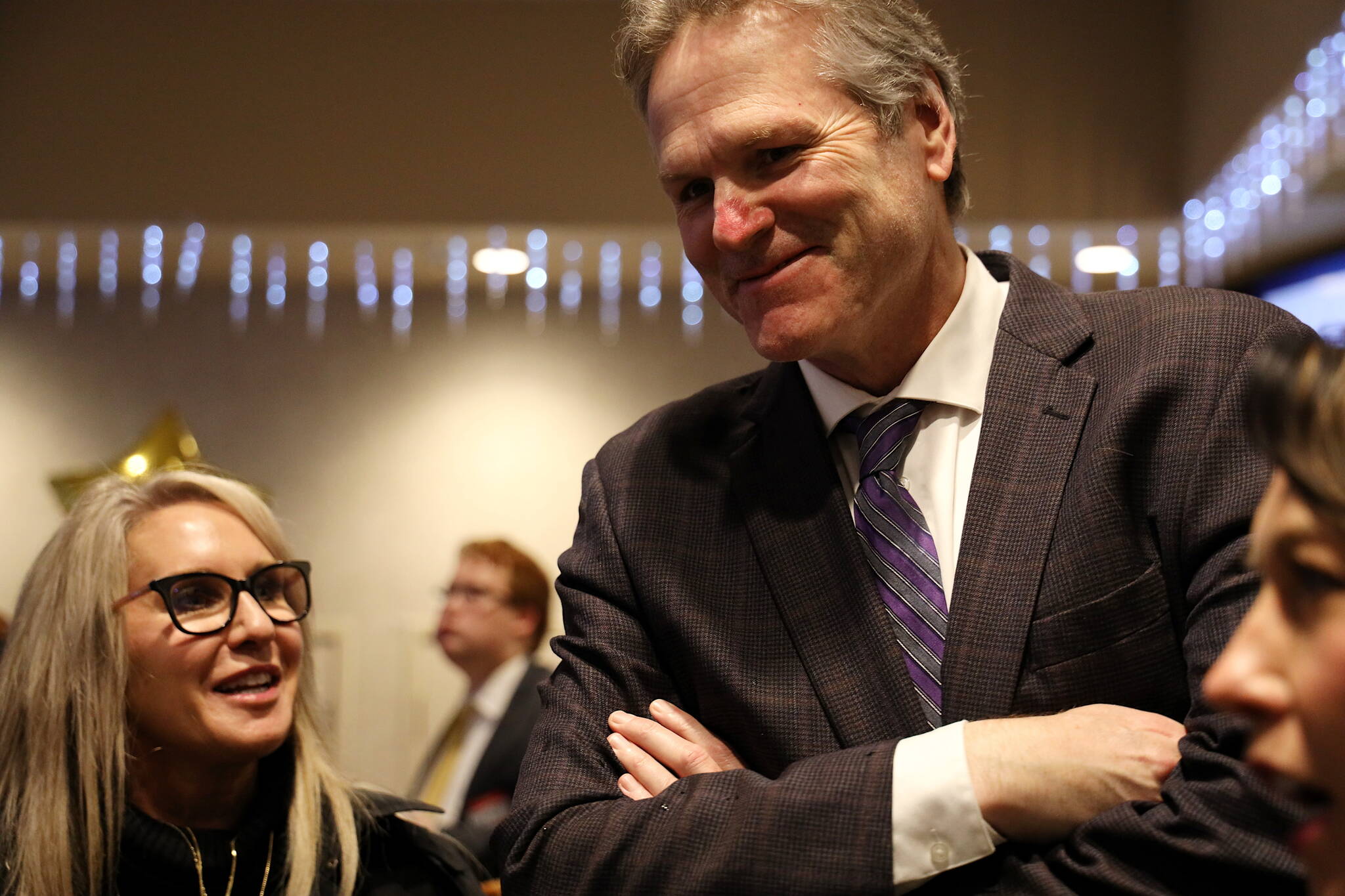 Gov. Mike Dunleavy talks with local residents and people involved with this year’s legislative session during an annual welcoming reception hosted by city government and business leaders Tuesday at Elizabeth Peratrovich Hall. Dunleavy is scheduled to deliver his annual State of the State address, the first of his second term, to a joint session of the Alaska State Legislature at 7 p.m. Monday. (Clarise Larson / Juneau Empire)