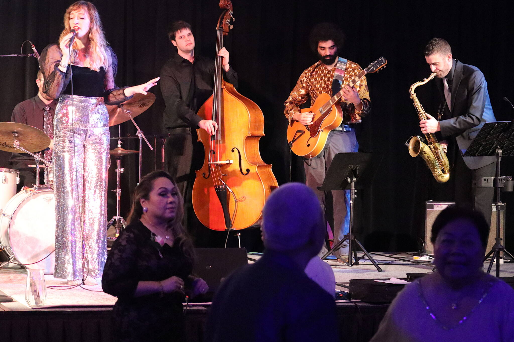 Juneau singer Taylor Vidic leads the Southeast Swingings in an evening of jazz performances during the inaugural celebration for Gov. Mike Dunleavy and Lt. Gov. Nancy Dahlstrom on Friday night at Elizabeth Peratrovich Hall. (Mark Sabbatini / Juneau Empire)