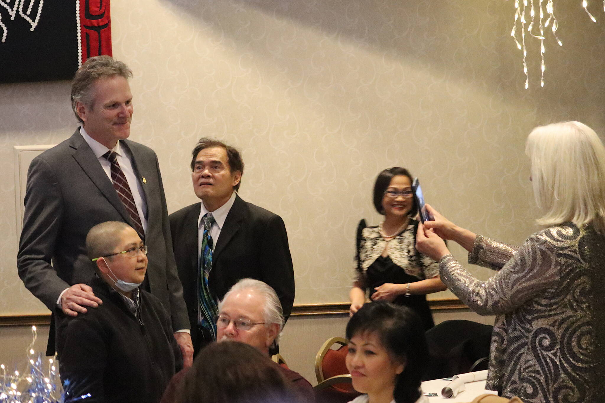 Gov. Mike Dunleavy poses for a photo with Gladys Castaños during an inaugural celebration for the governor and Lt. Gov. Nancy Dahlstrom on Friday night at Elizabeth Peratrovich Hall. (Mark Sabbatini / Juneau Empire)