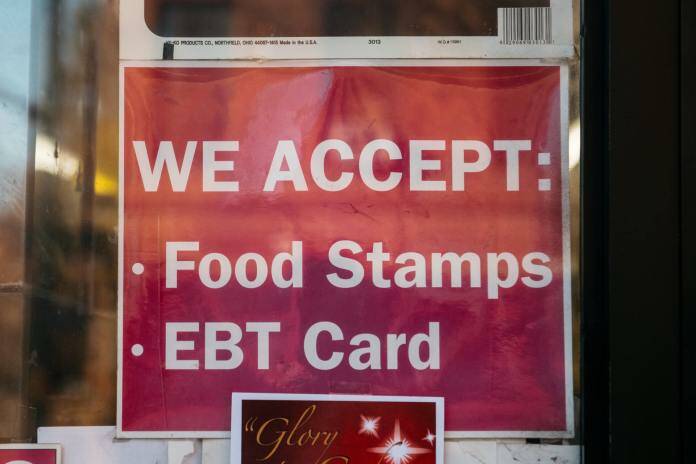 A sign for a store that accepts food stamps and exchange benefits transfer cards is seen in this 2019 photo. Ten Alaskans are suing the state over its failure to provide food stamps within the time frames required by federal law. (Photo by Scott Heins/Getty Images via Alaska Beacon)