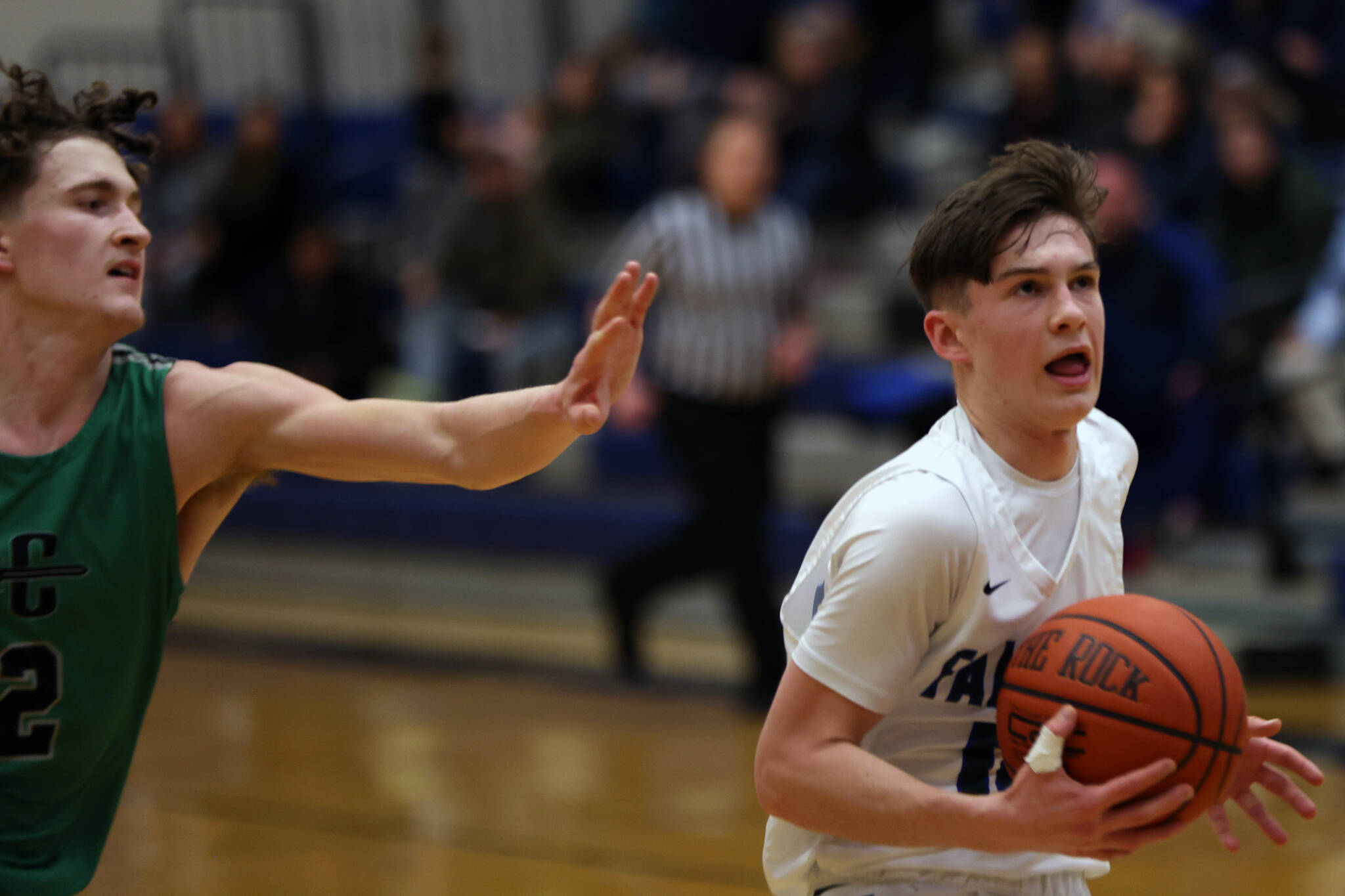 TMHS junior Samuel Lockhart makes his way past the outstretched arm of a Colony defender on his way to the hoop during a Thursday night home game. Lockhart would finish the game with a team-leading 17 points in the 52-41 loss. (Ben Hohenstatt / Juneau Empire)