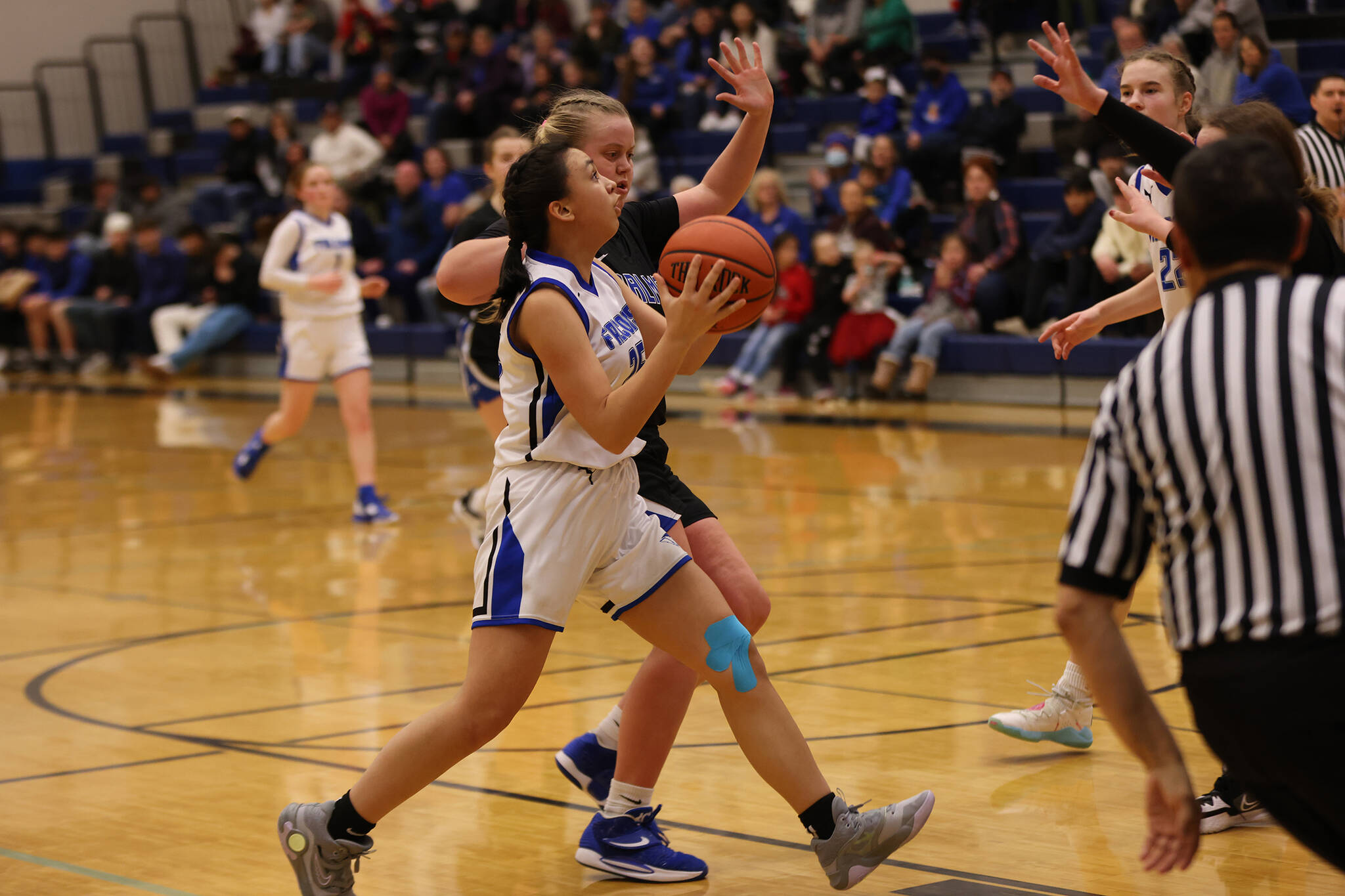 Sophomore Addison Wilson races toward the basket late in TMHS’ comeback win. Wilson was one of four players on her team to score 9 points. (Ben Hohenstatt / Juneau Empire)