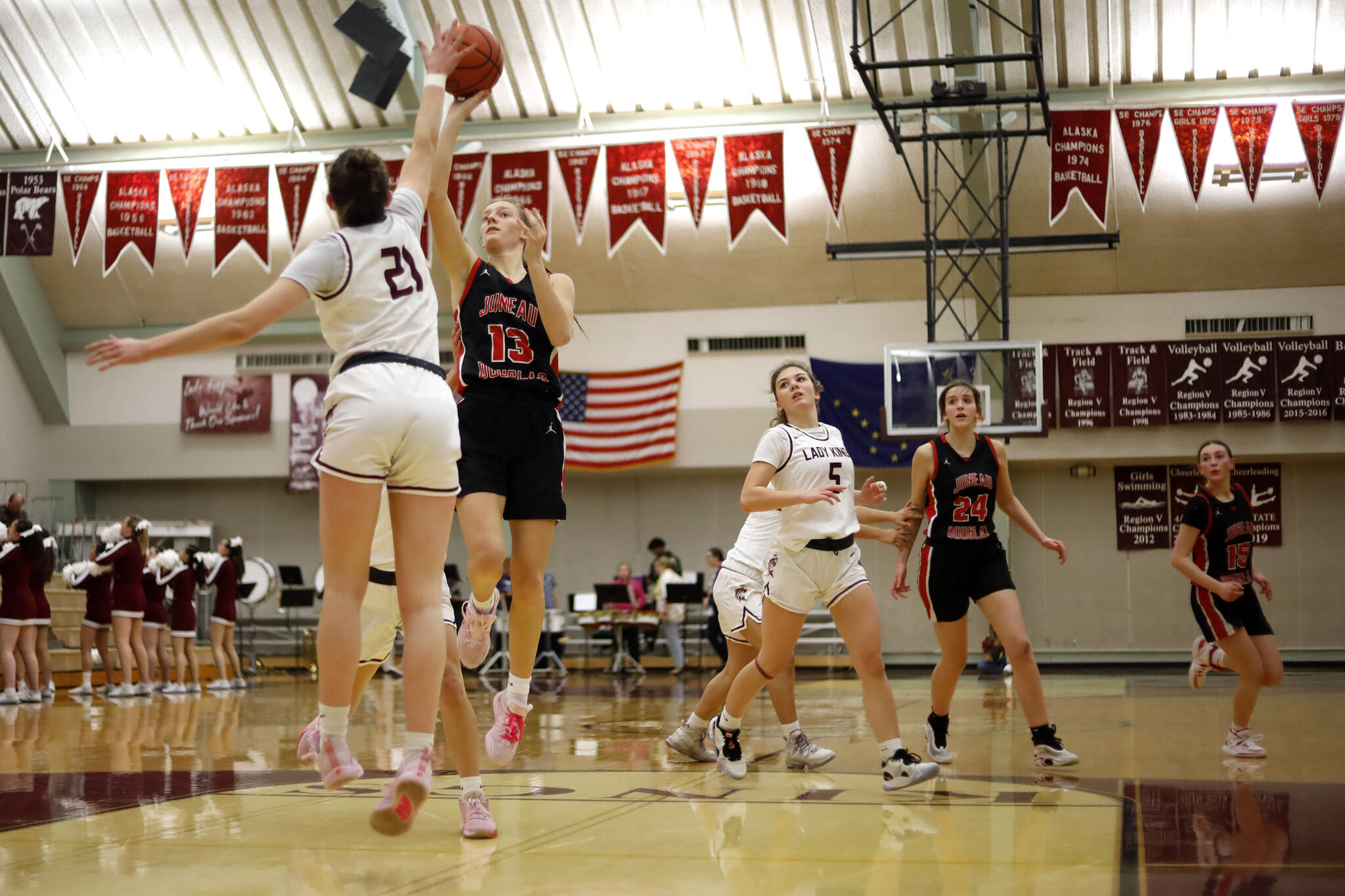 Kayhi’s Lindsay Byron (21) tries to block Juneau’s Skylar Tuckwood (13) as she attempts a layup Friday at Ketchikan High School. Juneau won 40 to 33. Photo by Christopher Mullen Ketchikan Daily News