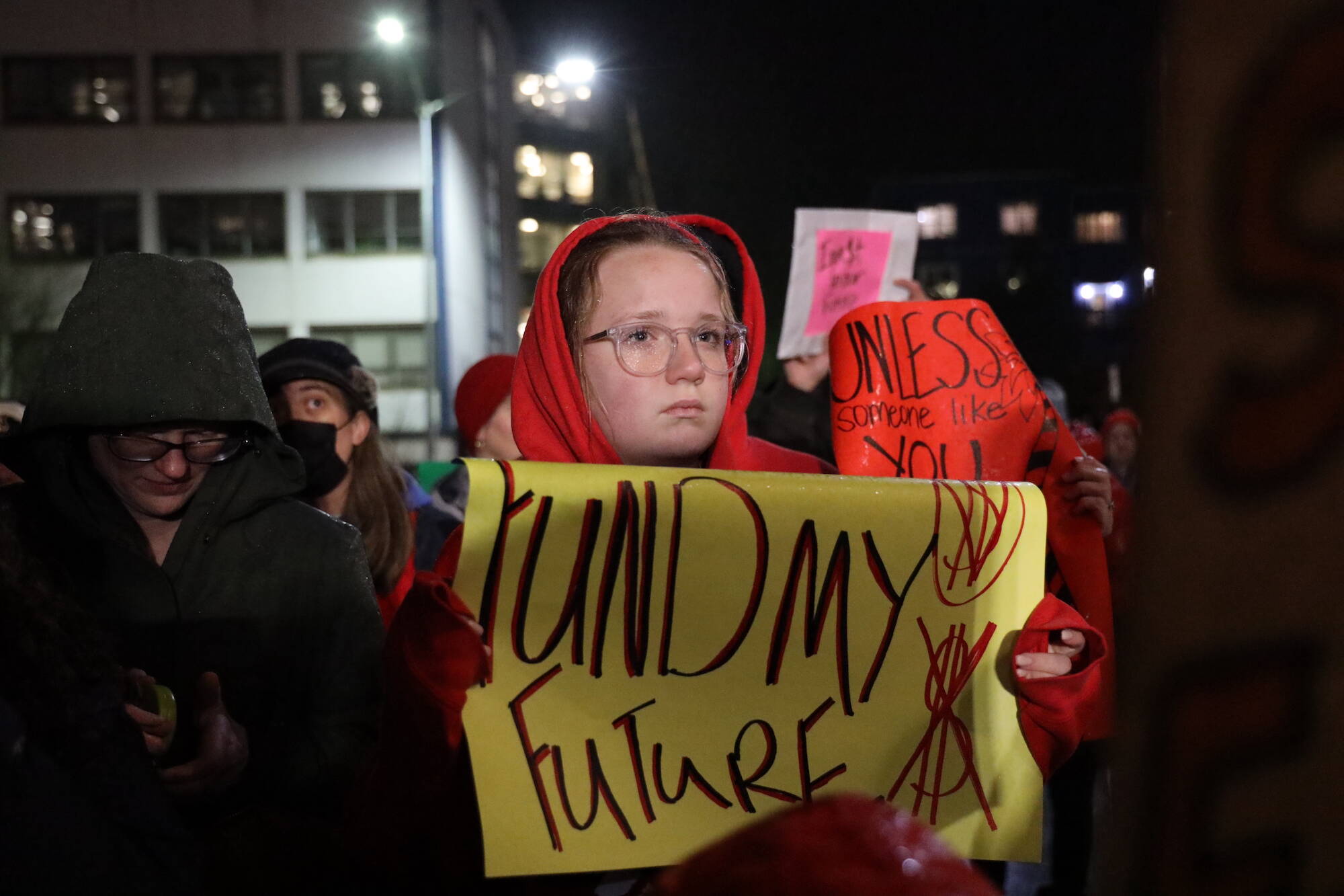 A student holds a sign during a rally at the steps of the Alaska State Capitol Monday evening in advocacy for an increase in the state’s flat funding via the base student allocation. (Clarise Larson / Juneau Empire)