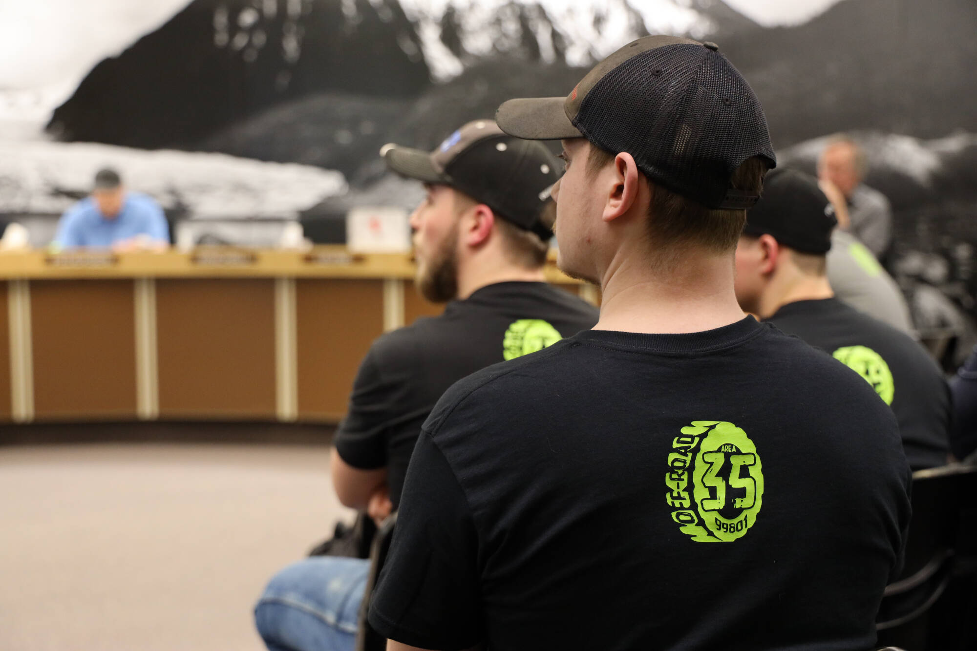 Residents wear matching shirts in advocacy for the proposed off-road vehicle riding park at 35 Mile which was up for permit consideration and later approved at the Tuesday evening planning commission meeting. ( Clarise Larson / Juneau Empire)