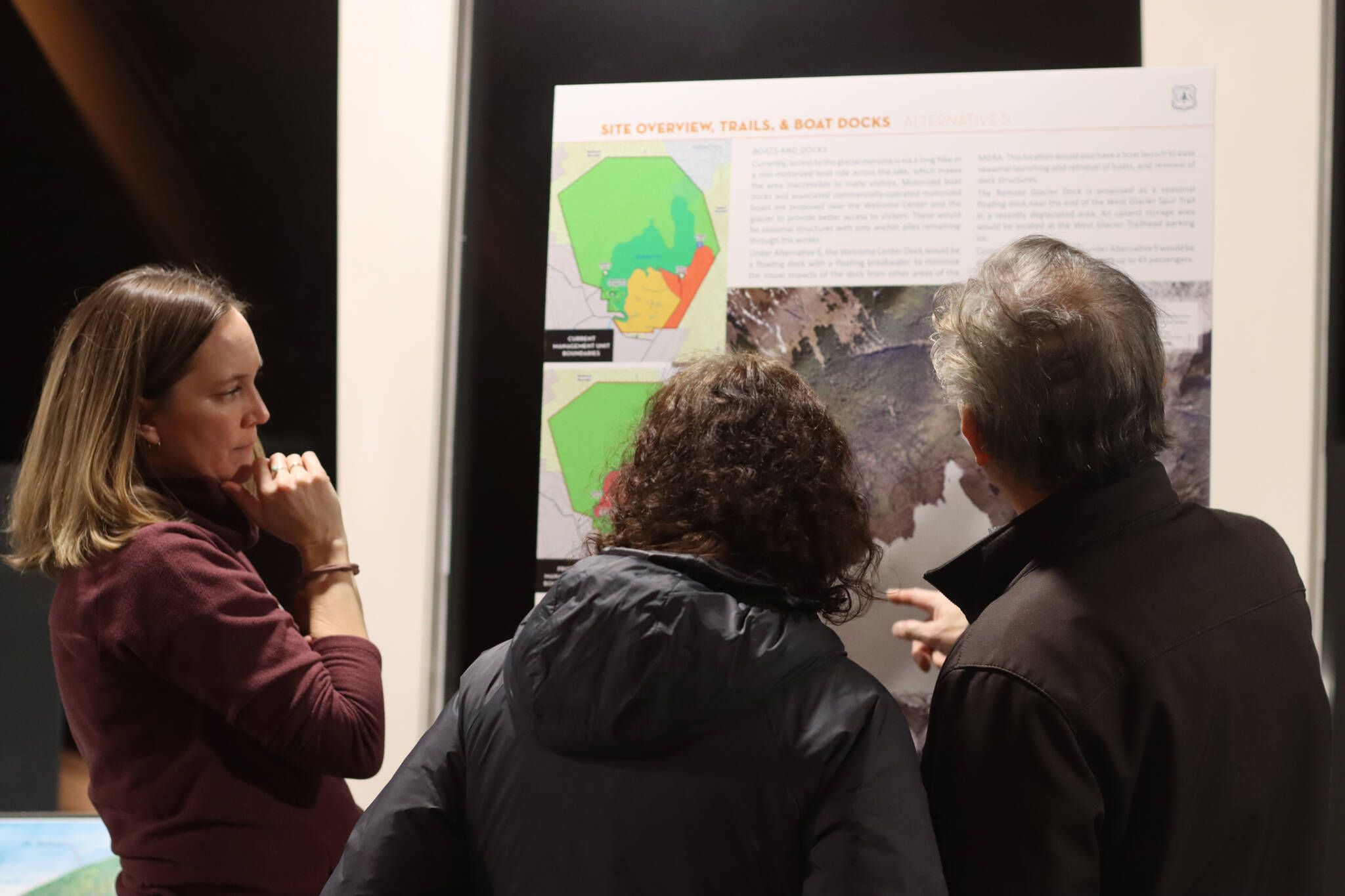 Carrie Connaker with Solstice Alaska Consulting meets with Juneau residents during an open house at the Mendenhall Glacier Visitor Center on Tuesday to help explain alternatives currently being proposed for the recreation area. (Jonson Kuhn / Juneau Empire)
