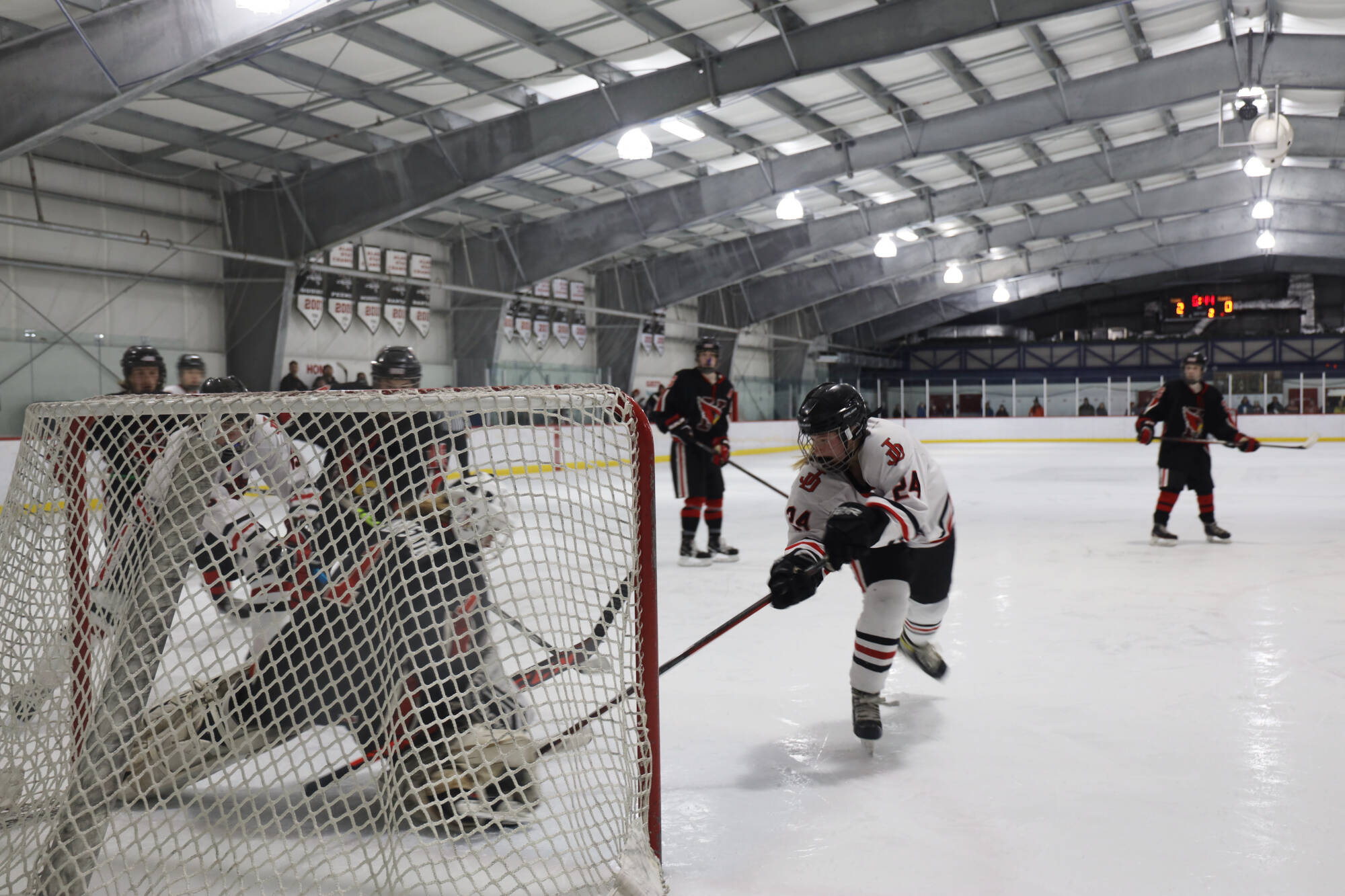 Clarise Larson / Juneau Empire 
Senior assistant captain Anna Dale attempts to stuff the net during a home game between Juneau-Douglas High School: Yadaa.at Kalé Crimson Bears Varsity hockey team and the Kenai Central Kardinals at the Treadwell Arena in early December.