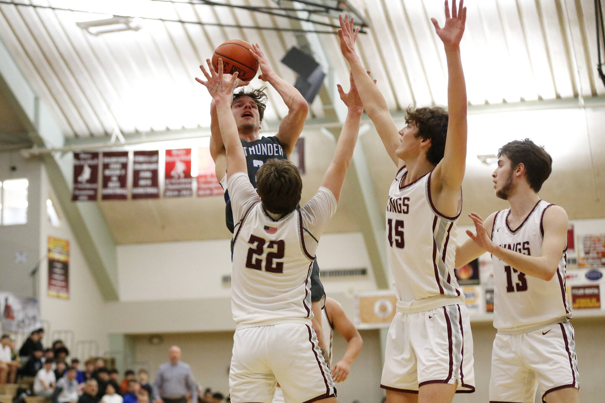 Thunder Mountain’s Thomas Baxter (30) prepares to shoot the ball as Kayhi’s Archie Dundas (22), Jared Rhoades (15), and Andrew Kleinschmidt-Guthrie (13) try to block him during Thunder Mountain’s 54-56 loss to Kayhi on Friday at Ketchikan High School. On Saturday, the Falcons won the rematch 60-58. (Christopher Mullen / Ketchikan Daily News)