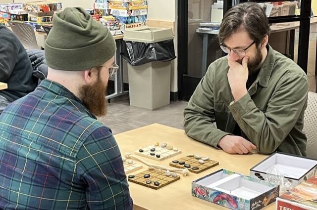 Eric Moots and Jacob Bubb carefully strategize the SHŌBU game at the Douglas Public Library on Saturday as part of Platypus Gaming's two-day mini-convention.  (Johnson Kuhn / Juno Empire)