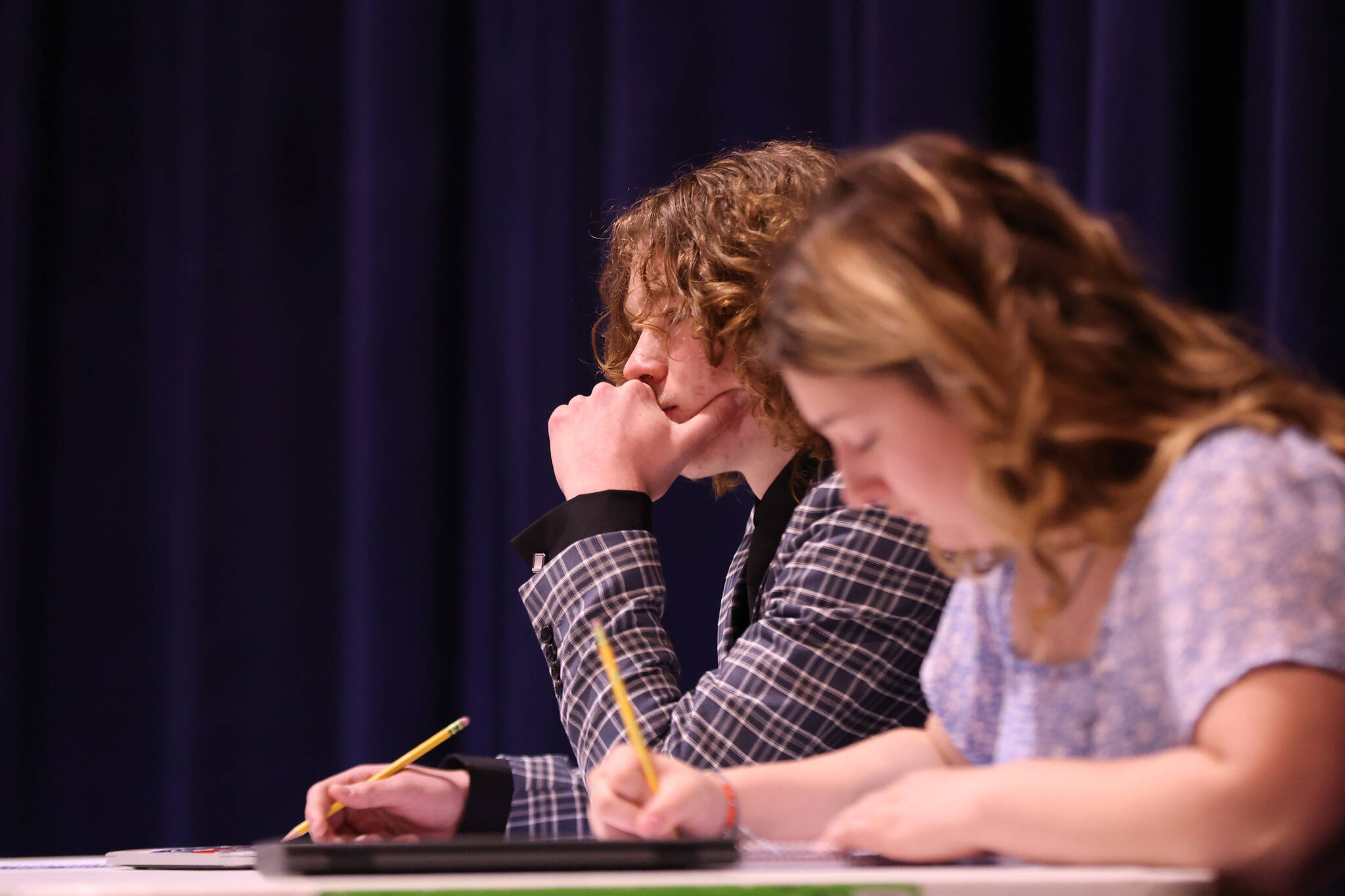 Killian Connolly and Kate Thomas of Ketchikan, who ultimately prevailed, take notes during the final debate at the Region V Drama, Debate and Forensics Tournament. (Ben Hohenstatt / Juneau Empire)