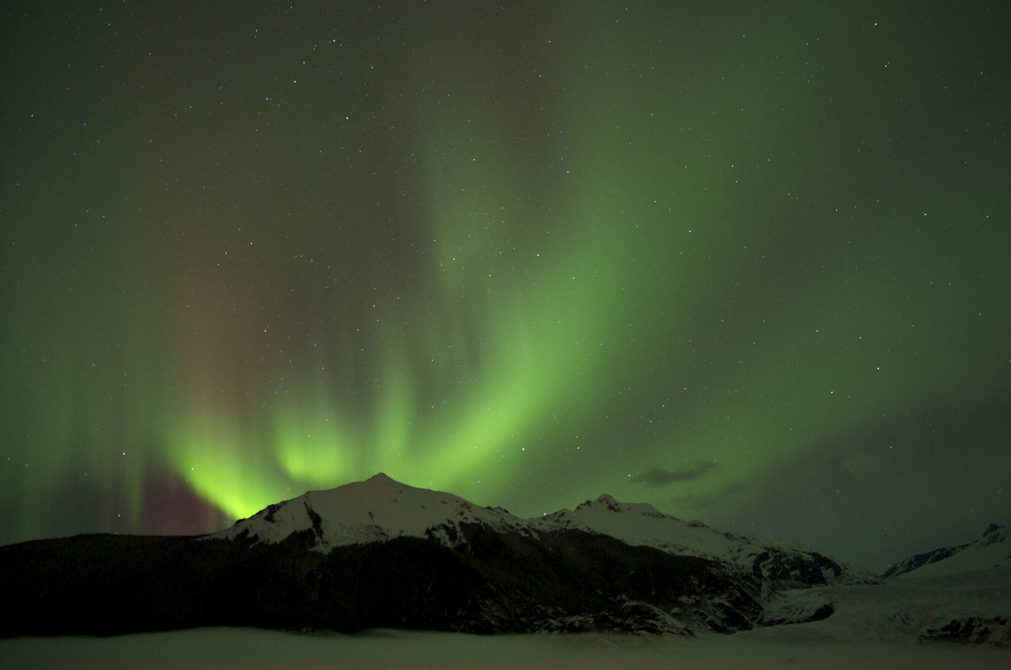 The Aurora Borealis glows over the Mendenhall Glacier in 2014. (Michael Penn / Juneau Empire File)