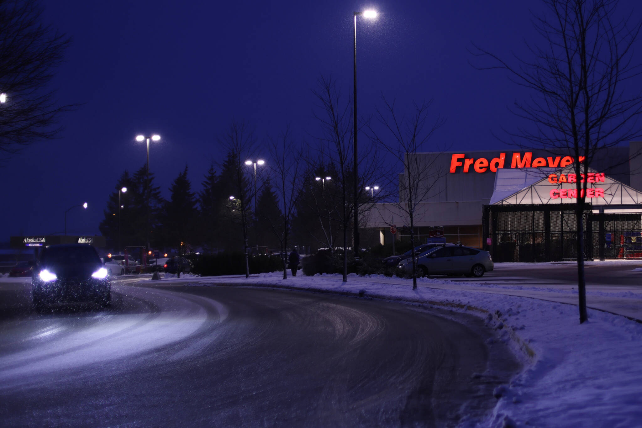 A vehicle exits the Juneau Fred Meyer parking lot on Wednesday. Juneau Police Department is investigating a report of a threat made against the store. (Ben Hohenstatt / Juneau Empire)