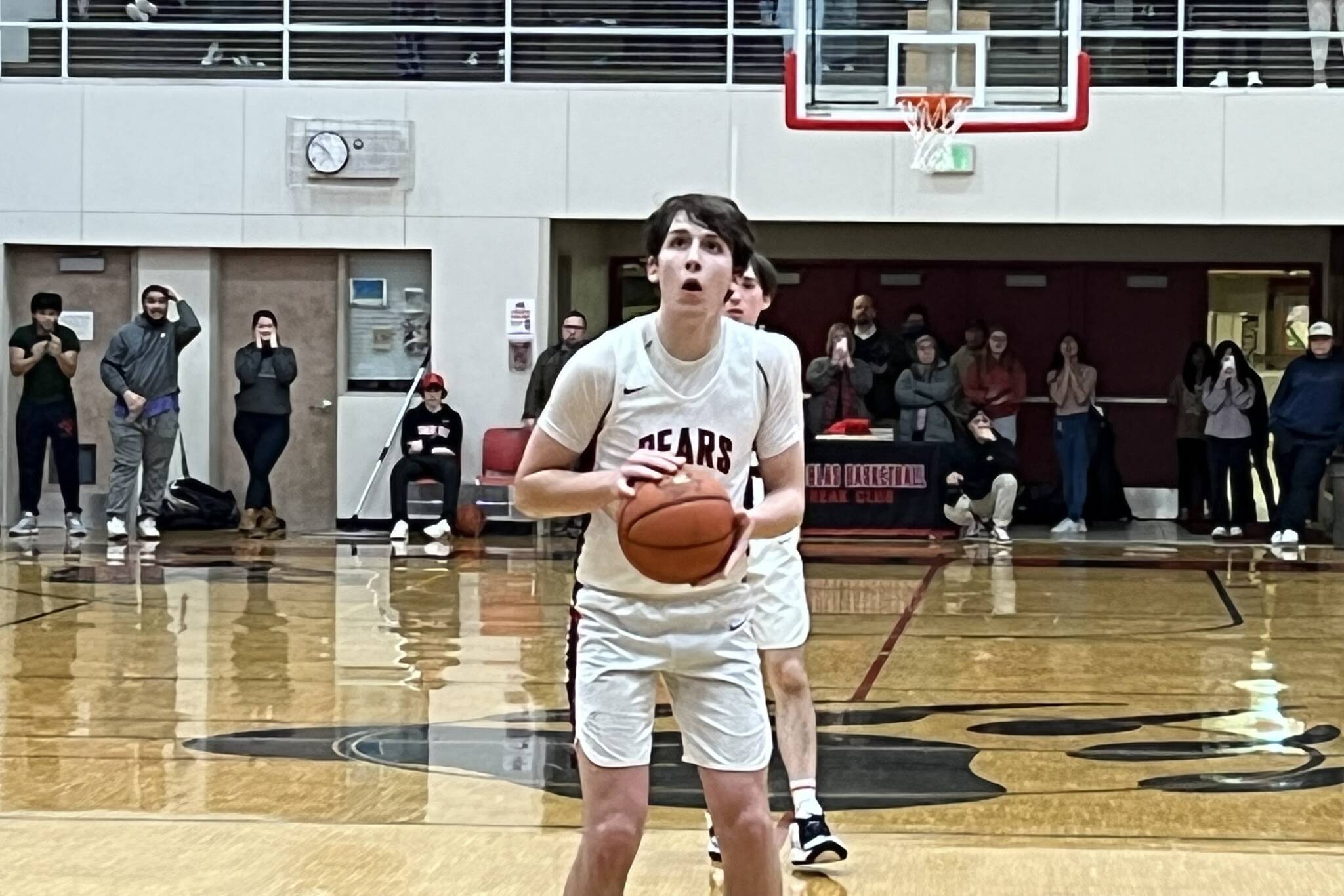 JDHS senior Kai Hargrave sets up to take the first of two free throw shots with 1.7 seconds left in Wednesday night’s game against Thunder Mountain High School. Hargrave’s last second shot secured the win for the Crimson Bears in their first conference game of the season. (Jonson Kuhn / Juneau Empire)