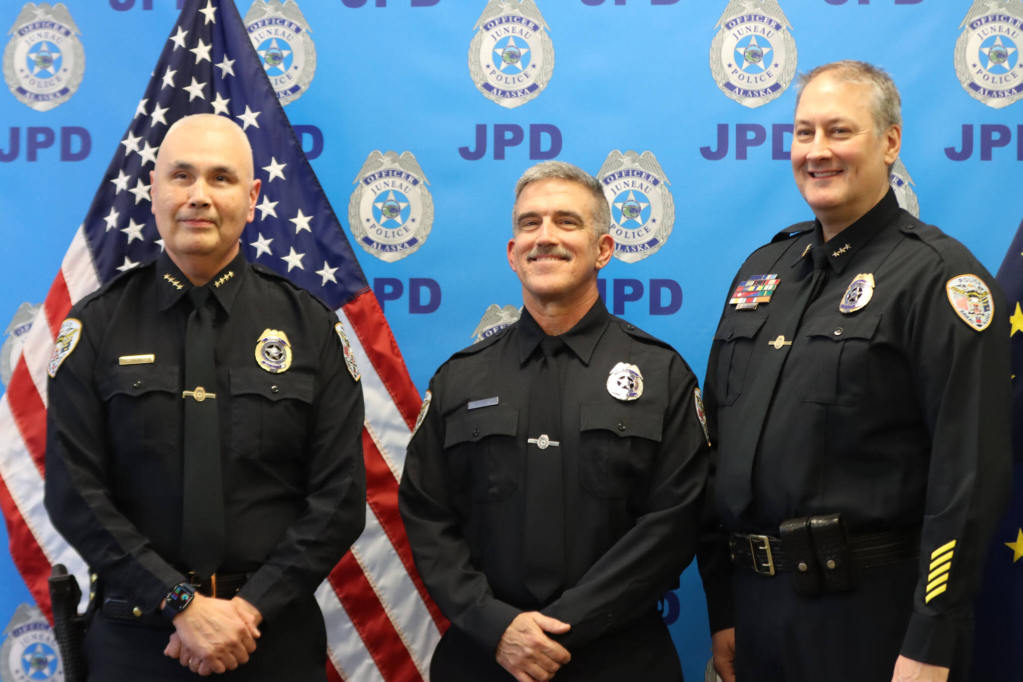 Officer William Hicks stands with JPD Chief Ed Mercer and Deputy Chief David Campbell during a swearing in ceremony for Hicks on Thursday at the JPD station in Lemon Creek. (Jonson Kuhn / Juneau Empire)