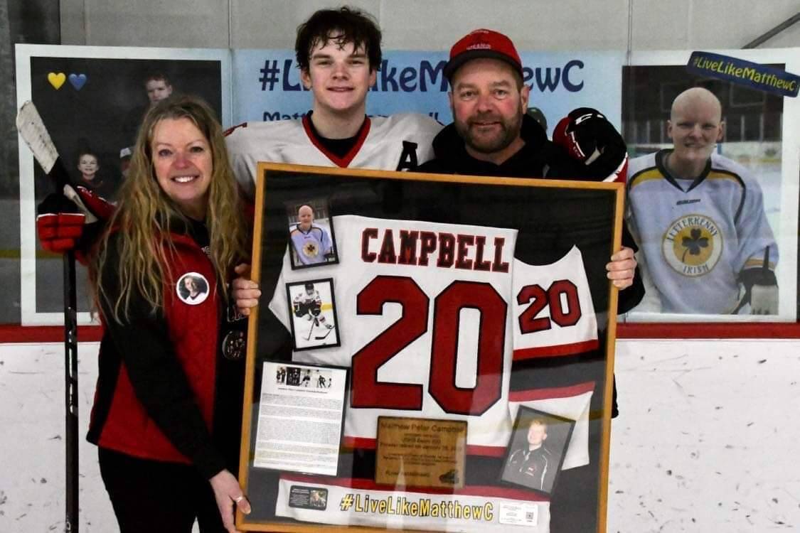 The Campbell family poses for a photo in Treadwell Arena during the last Crimson Bears home hockey game of the season. (Courtesy Photo)