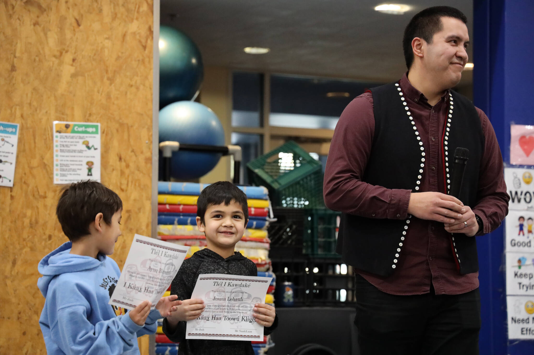 Ayuq Blanehett and Josaia Lehauli recieve awards for their work at the Tlingit Culture Language and Literacy program at Harborview Elementary School Monday morning. (Clarise Larson / Juneau Empire)
