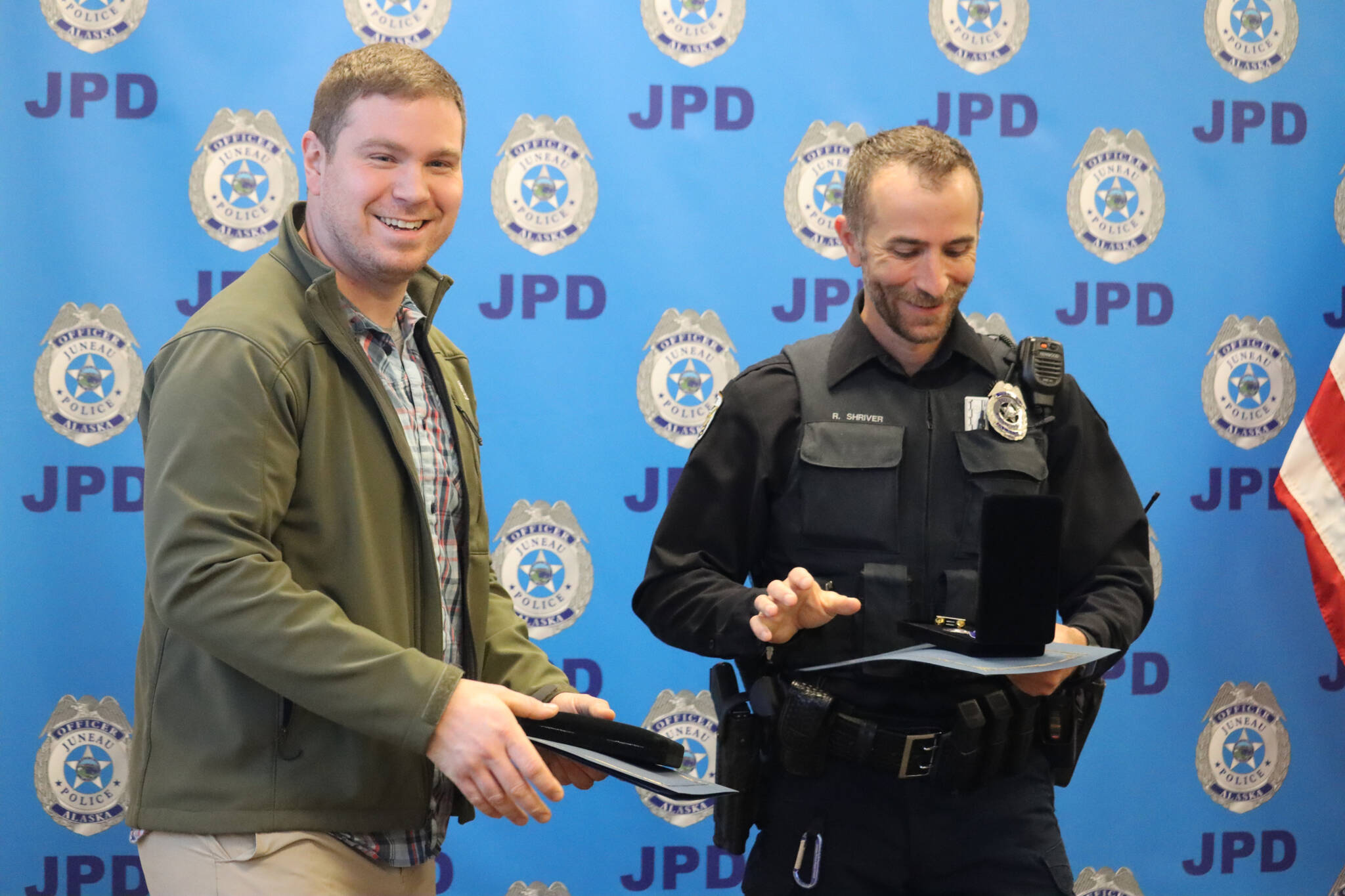 JPD Officers Patrick Vaughan and Ron Shriver receive awards for their involvement within the same incident during the department’s award ceremony on Monday. Vaughan received the Medal of Bravery and Shriver received the Outstanding Police Service Medal. (Jonson Kuhn / Juneau Empire)