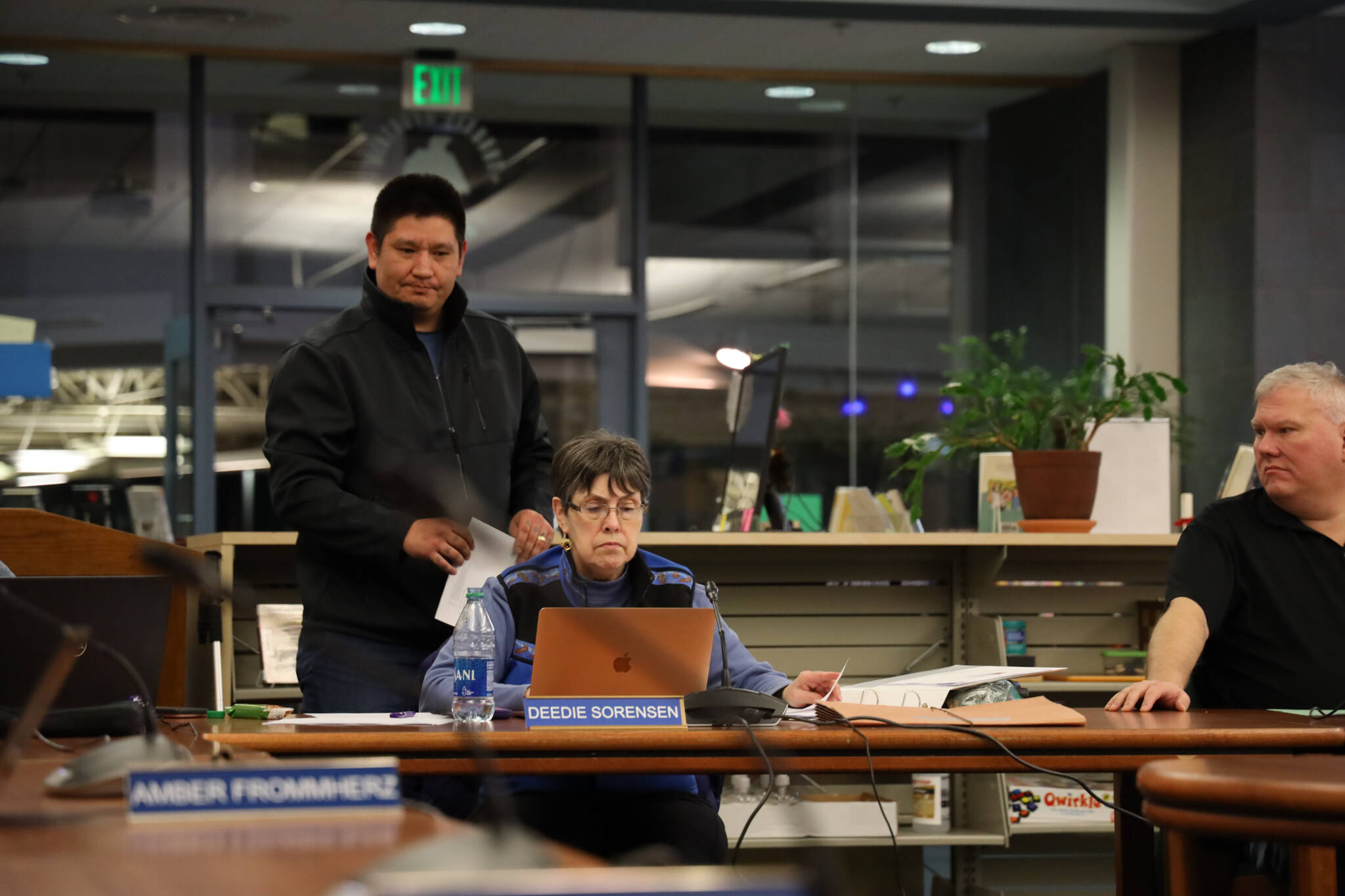 Clarise Larson / Juneau Empire
Nick Nelson passes out paper copies of a notice of appeal to school board members Tuesday night regarding the district’s decision on a racism complaint at Juneau-Douglas High School: Yadaa.at Kalé he filed in early December.
