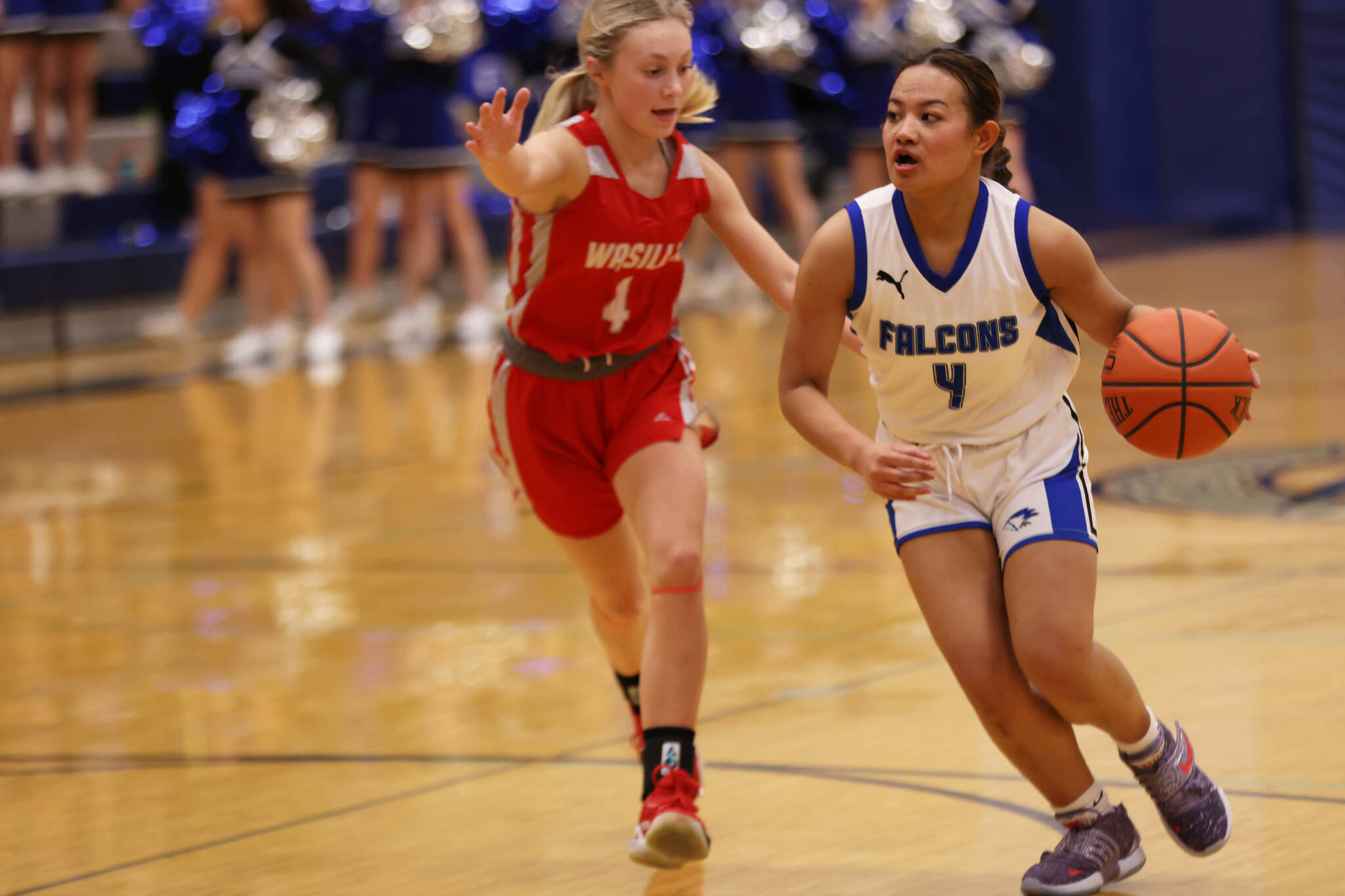 Mikah Carandang dribbles while surveying the court during a home game against Wasilla. She was tightly defended by Meilee Merchant. (Ben Hohenstatt / Juneau Empire File)