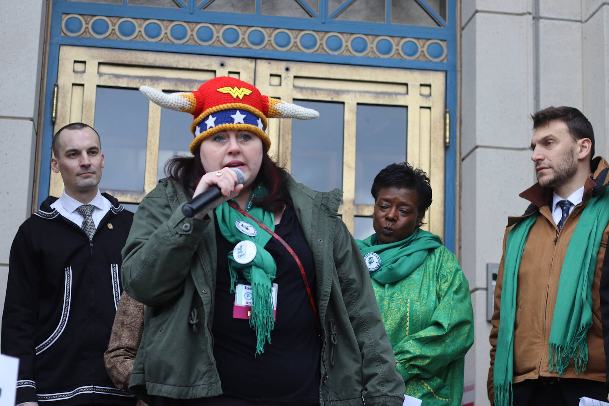 Joey Tillson, a state Division of Public Assistance employee in Ketchikan, addresses a state employees’ rally while wearing what she called a warrior hat in front of the Alaska State Capitol on Friday. Participants are trying to convince lawmakers to remedy staffing shortages allegedly caused by problems such as poor wages and poor treatment. (Mark Sabbatini / Juneau Empire)
