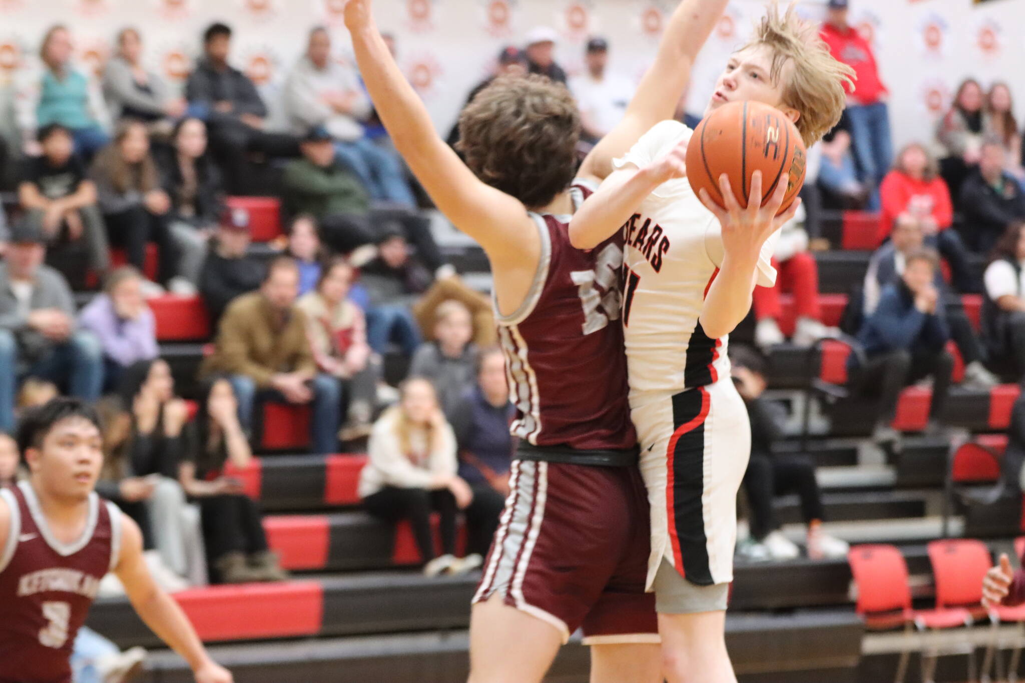 JDHS junior Sean Oliver puts up a tricky lay up against Ketchikan High School during a conference game Friday night. Oliver was second in leading his team in scores for a total of 16 points. (Jonson Kuhn / Juneau Empire)