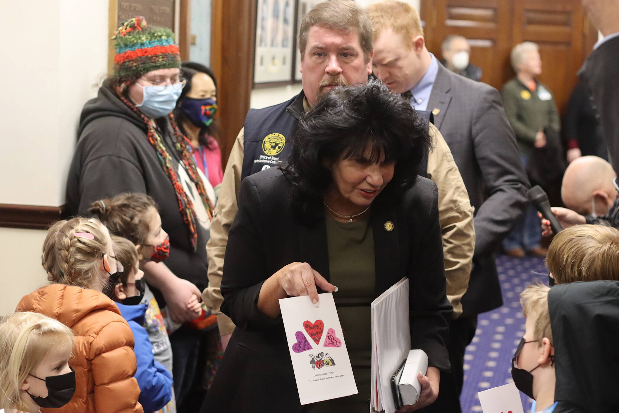 Alaska House Speaker Cathy Tilton, R-Wasilla, accepts a Valentine’s Day card from a Montessori Borealis preschool student in the hallway outside the House chamber at the Alaska State Capitol on Monday. A couple dozen youths from the Juneau Montessori program visited with their parents and teachers during the morning, lobbying for an increase in education funding. Tilton said during a subsequent press briefing she is not ruling out an increase, but is interested in “outside the box” alternatives. (Mark Sabbatini / Juneau Empire)