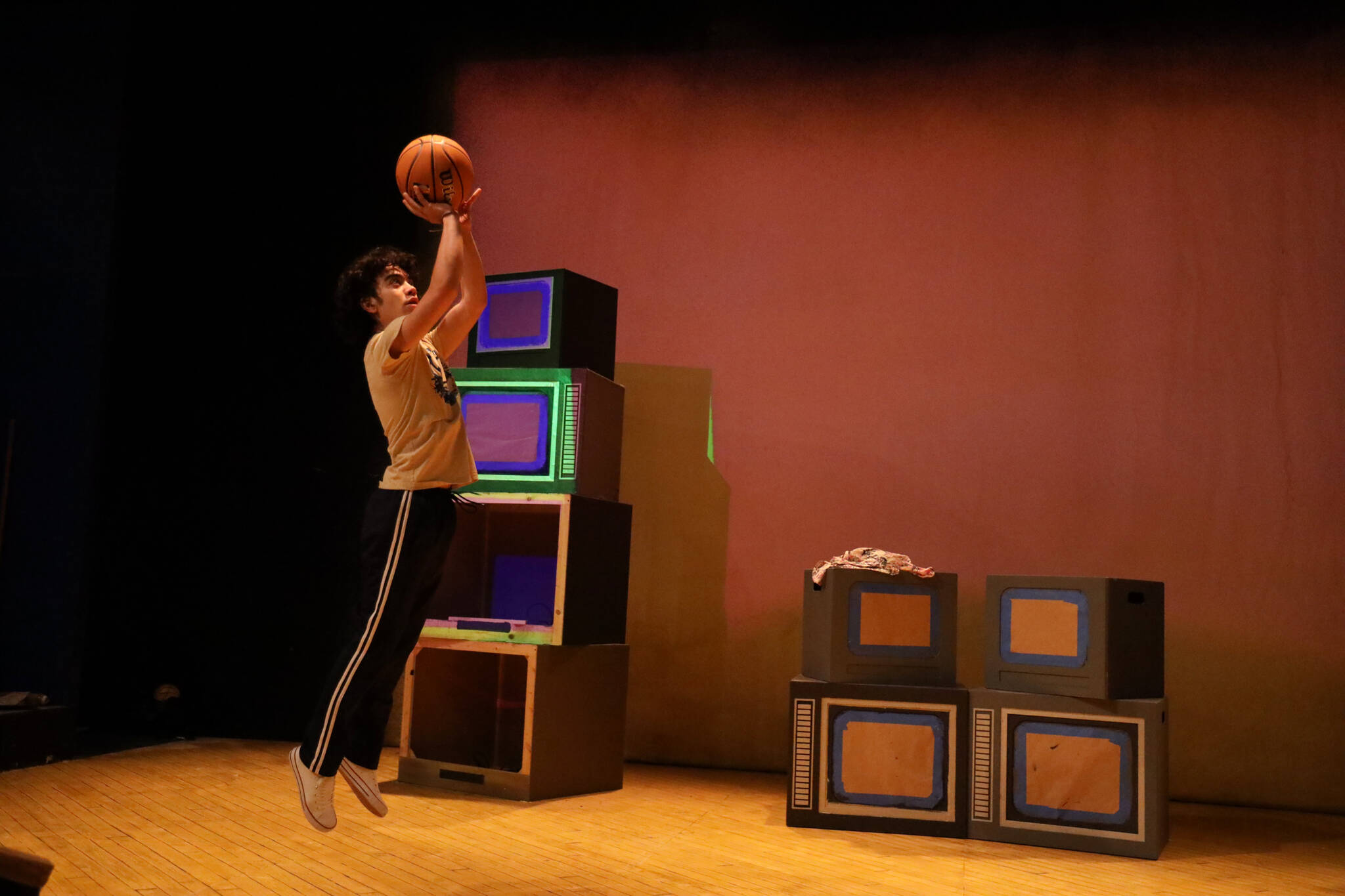 Manford Lum (Morgan Gwilym Tso) takes a jump shot during a scene rehearsal performance of Perseverance Theatre’s upcoming play “The Great Leap” opening Friday evening. (Clarise Larson / Juneau Empire)