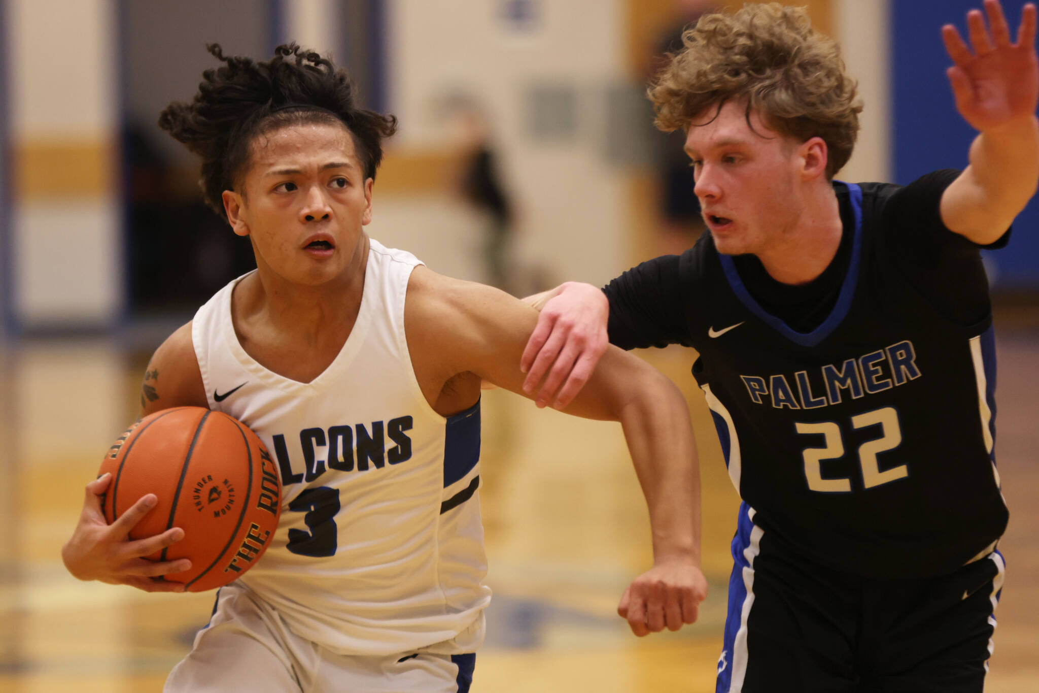 TMHS junior Lance Nierra (3) races toward the hoop while defended by Palmer senior Chad Landon (22). Nierra finished the game with 6 points. (Ben Hohenstatt / Juneau Empire)