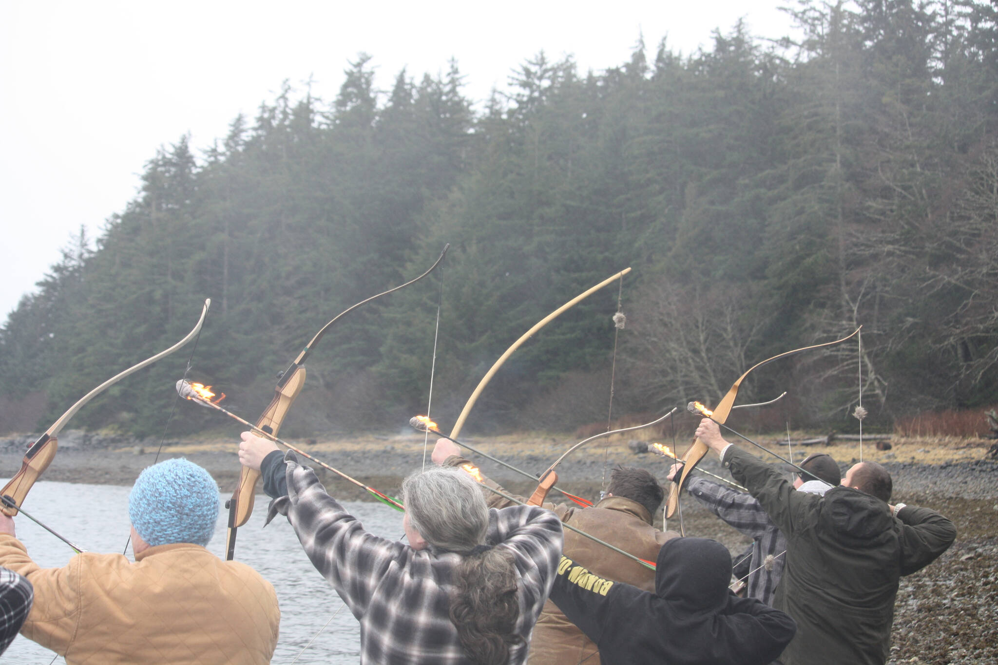 Family and friends of Daniel Sargent shoot flaming arrows into Auke Bay on Saturday during Sargent’s memorial at Raven Shelter. Sargent was one of the founding members of the Juneau Archery Club and was survived by his wife Lavena and daughter Tiffany Sargent Hallquist. (Jonson Kuhn / Juneau Empire)