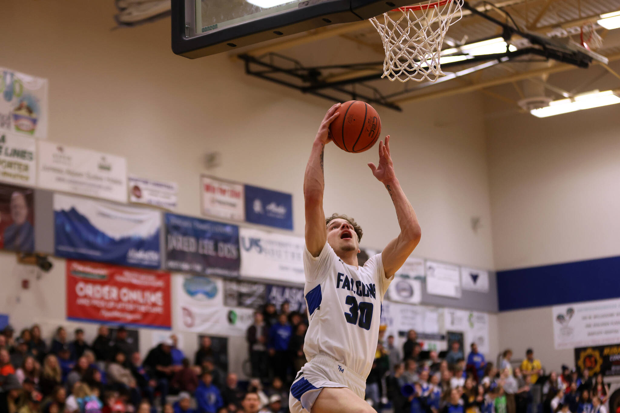 TMHS junior Thomas Baxter rises for a layup on a fastbreak during a Saturday night game against Ketchikan. Baxter on Feb. 9 became the fastest Falcon to reach 1,000 points and is now the school’s third leading scorer. (Ben Hohenstatt / Juneau Empire)