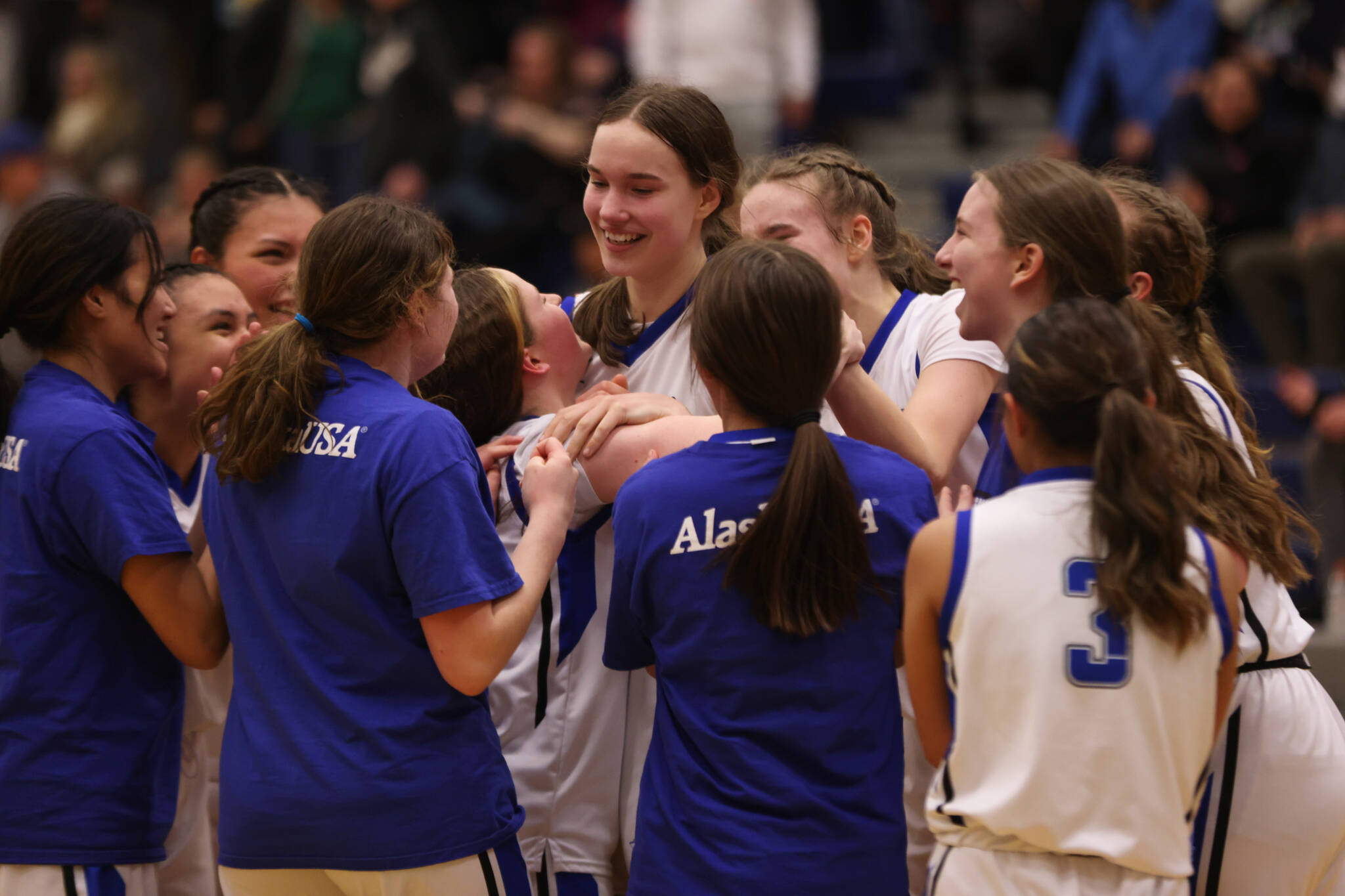 TMHS sophomore Cailynn Baxter (center) is swarmed by teammates following a last-second, game-winning shot against JDHS Tuesday night. The teams have met two times so far this season and each game has come down to the wire. (Ben Hohenstatt / Juneau Empire)