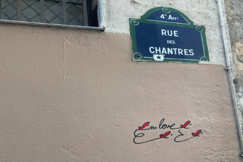 Near the spot where Héloïse and Peter Abelard fell in love, concise graffiti offers a testament of more recent lovers, four red hearts flitting like butterflies around two simple words in English: “in love.” (Courtesy Photo)