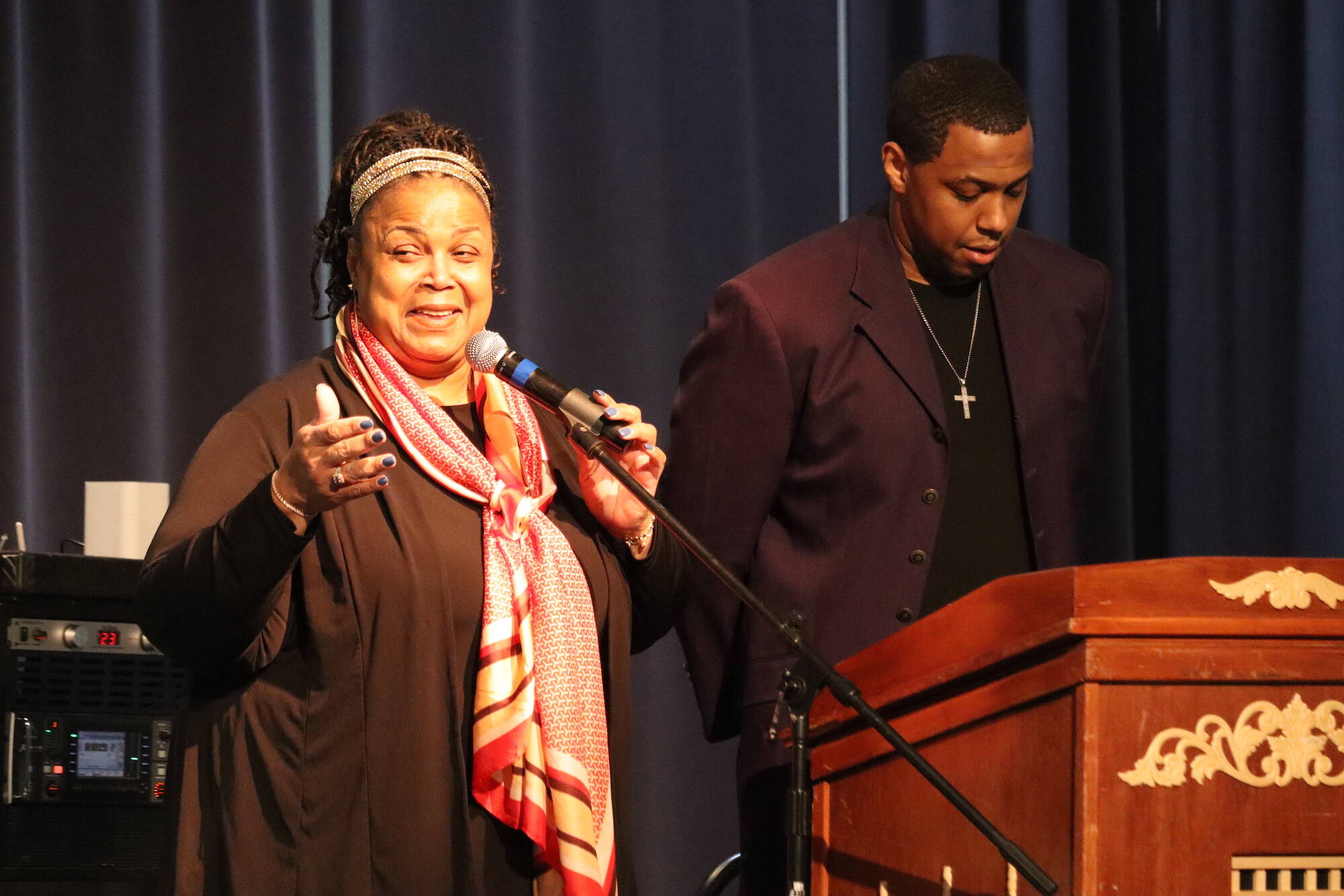 Black Awareness Association president Sherry Patterson and her son and evening’s emcee Michael Patterson address a full crowd after leading a prayer at the Juneau Arts and Culture Center on Saturday during Rise, a Black History Month celebration. (Jonson Kuhn / Juneau Empire)